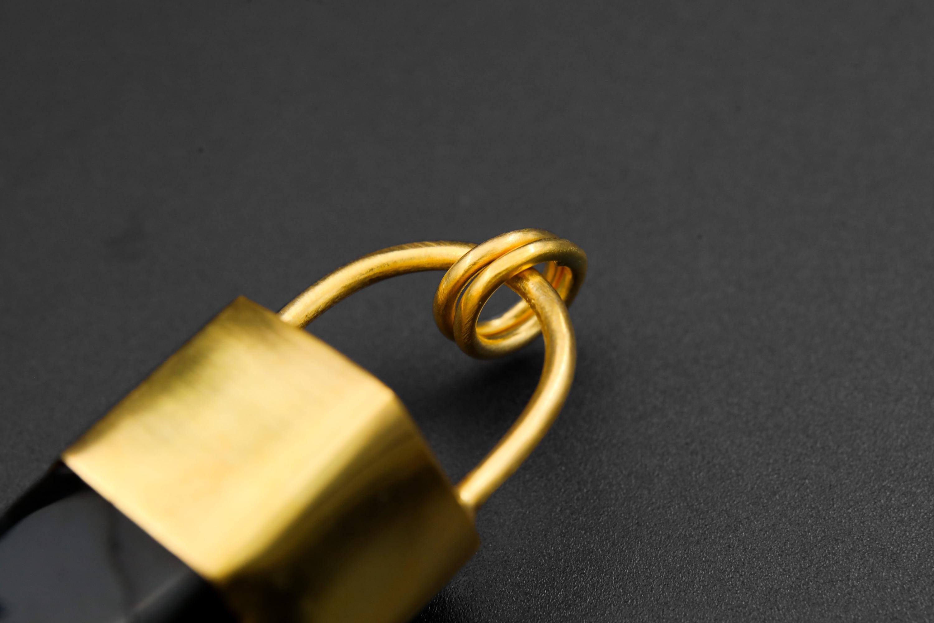 Detailed view of gold-plated bronze bail and cap on Large Smoky Quartz point pendant.