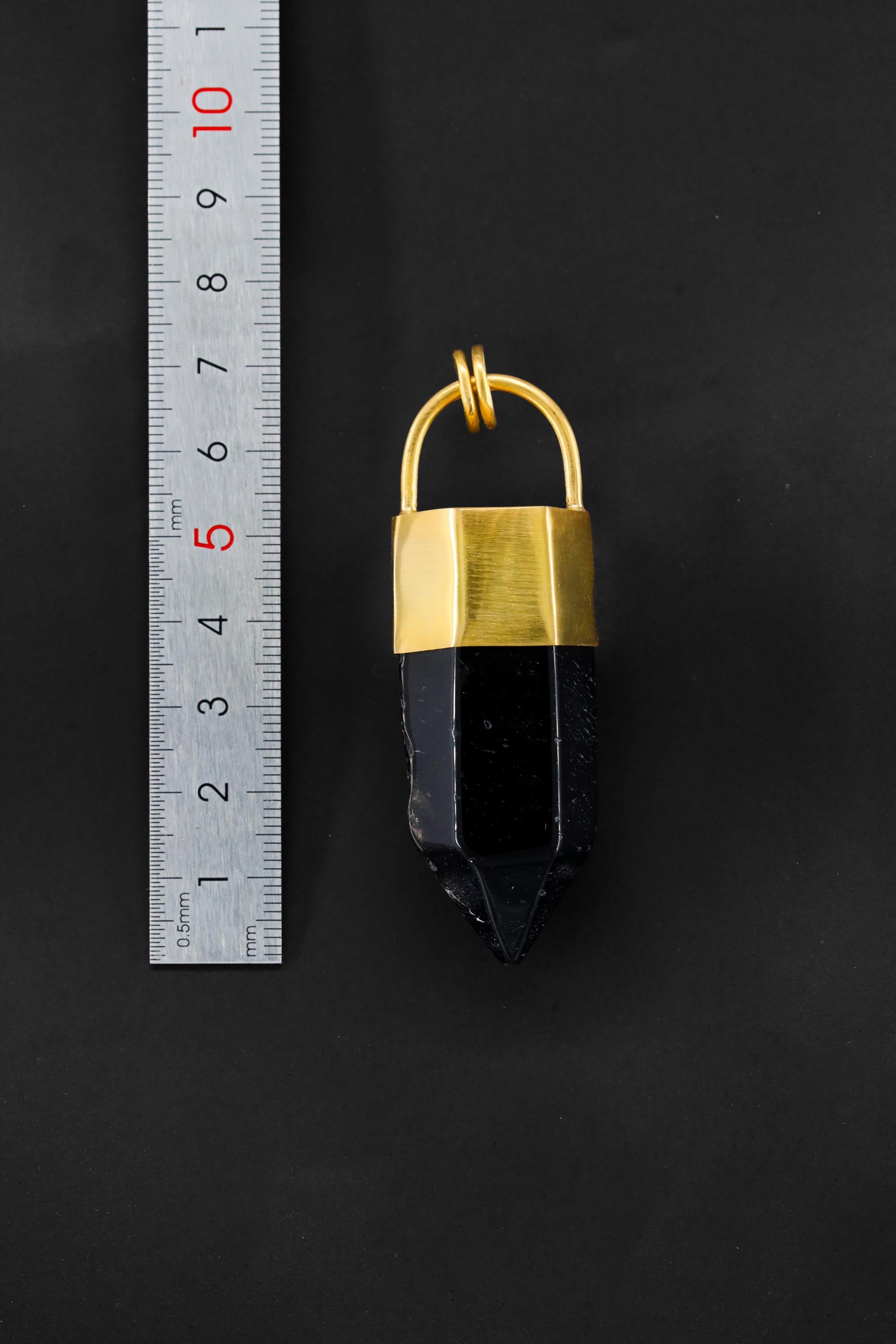 Large Smoky Quartz point pendant shown beside a ruler for scale with 7 cm crystal body and gold cap.