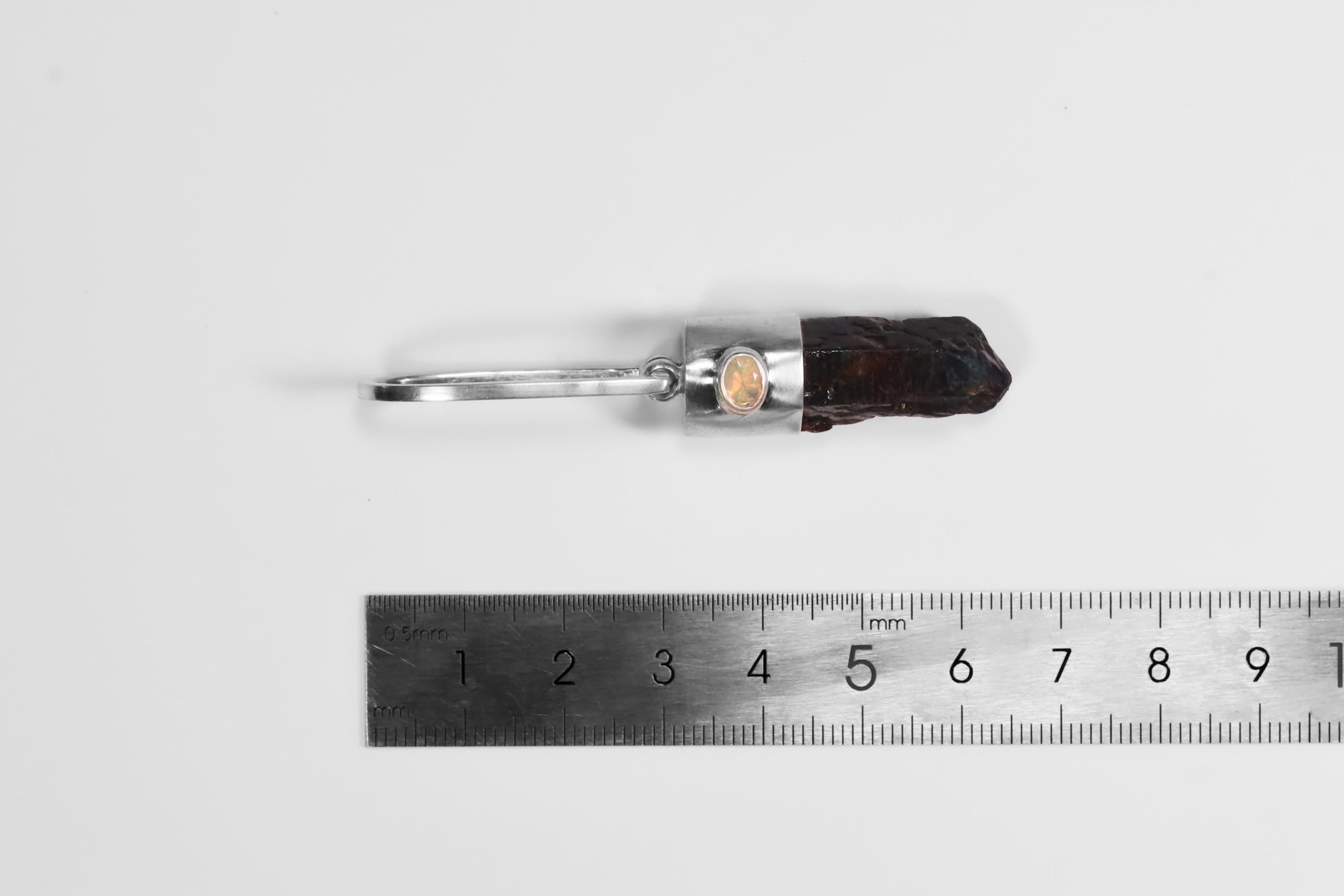 Blue Apatite Ethiopian Opal pendant shown beside a ruler for scale, measuring approximately 7 cm long.
