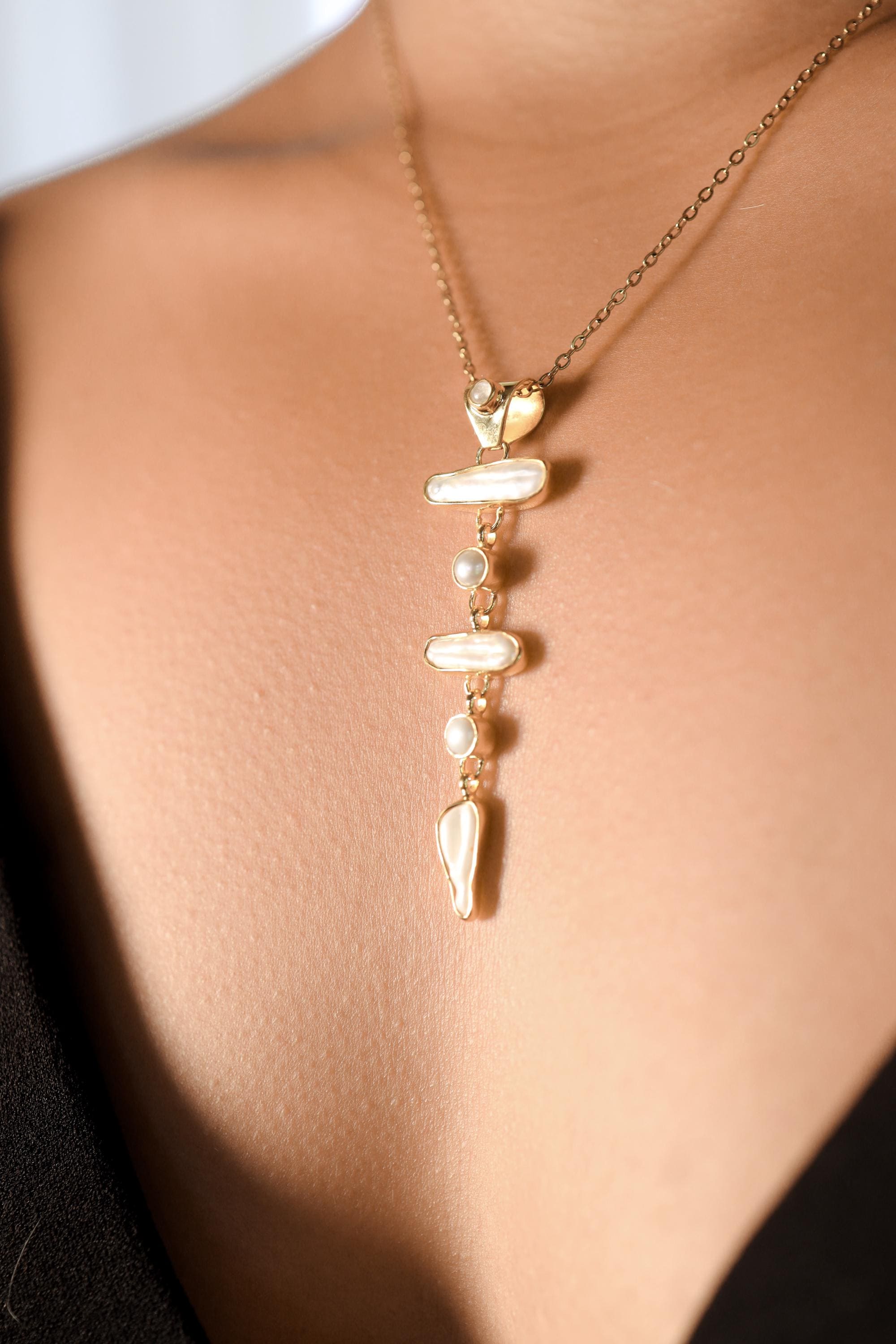Blue Moonstone and Baroque Pearl cascade pendant worn on a model as an elegant lunar-inspired necklace.