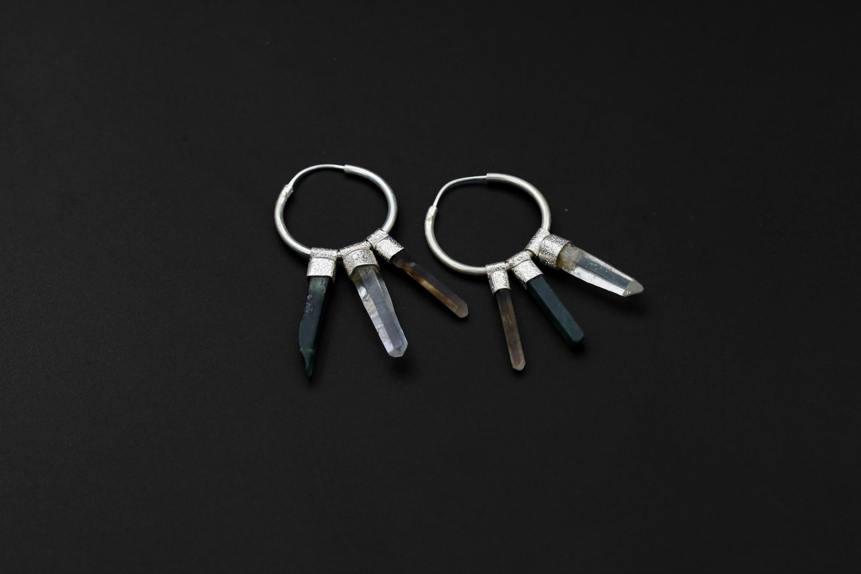 Close-up of Green Jade, Smoky Quartz, and Clear Quartz dangles on sterling silver hoop earrings.