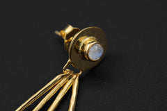 Close-up of Blue Moonstone stud earring showing round gemstone centre, hammer texture, and dangling moon ray spikes.
