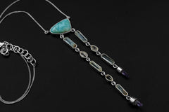 Atlantian Larimar Ocean Talisman shown on a dark background with Larimar, Aquamarine, Herkimer Diamond, Vera Cruz Quartz, and sterling silver chain.