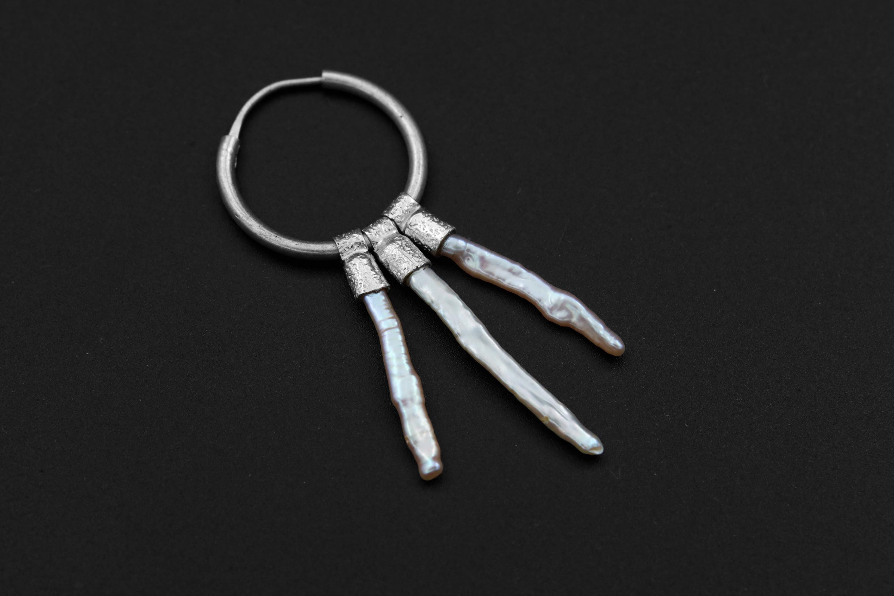Moonlit Pearl stack hoop earring shown on dark background with polished sterling silver and luminous White Pearls.