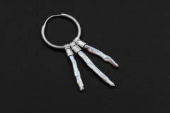 Moonlit Pearl stack hoop earring shown on dark background with polished sterling silver and luminous White Pearls.