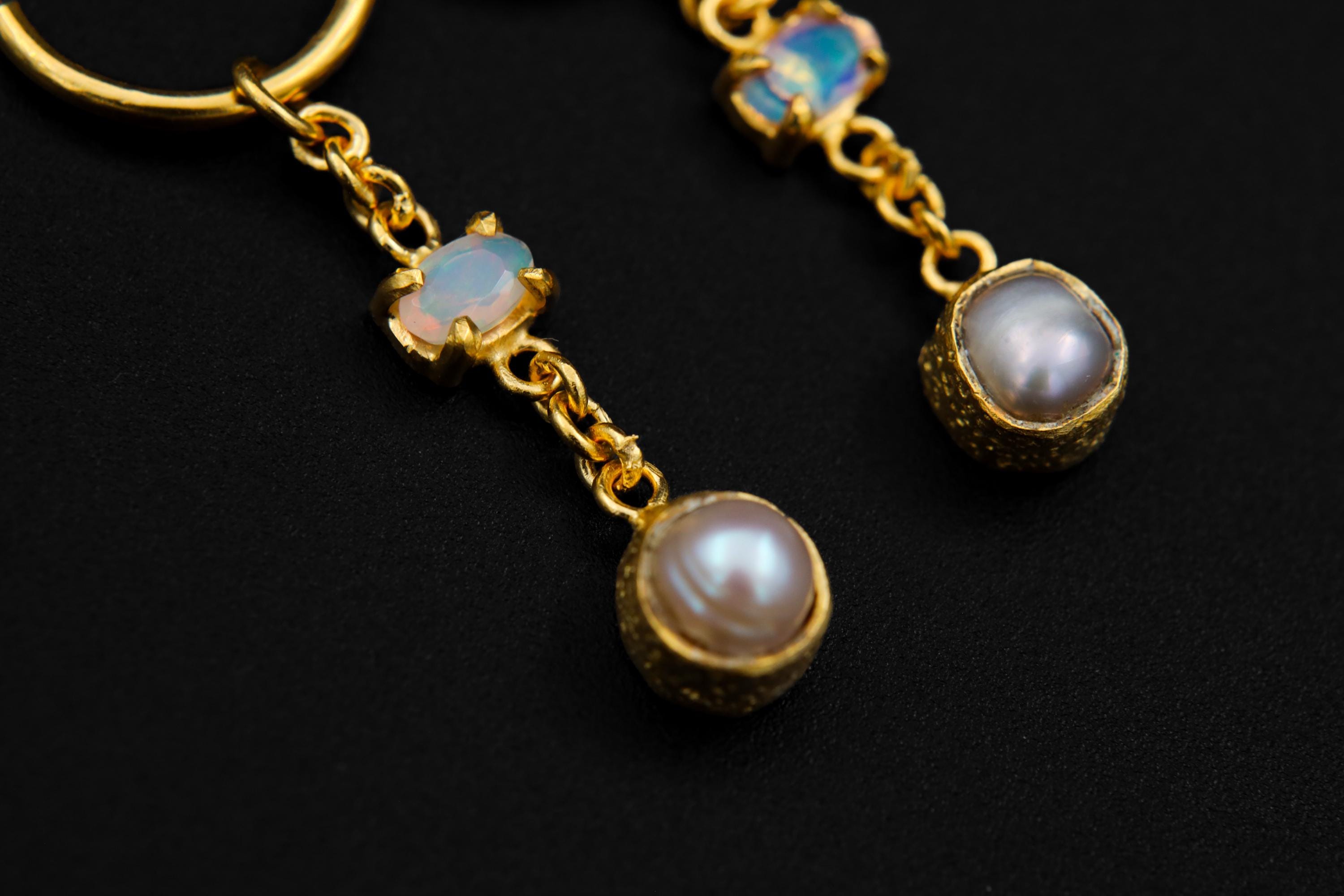 Close-up of Golden Ethiopian Opal Pearl earrings showing faceted Opal colour play and soft white Pearl accents.