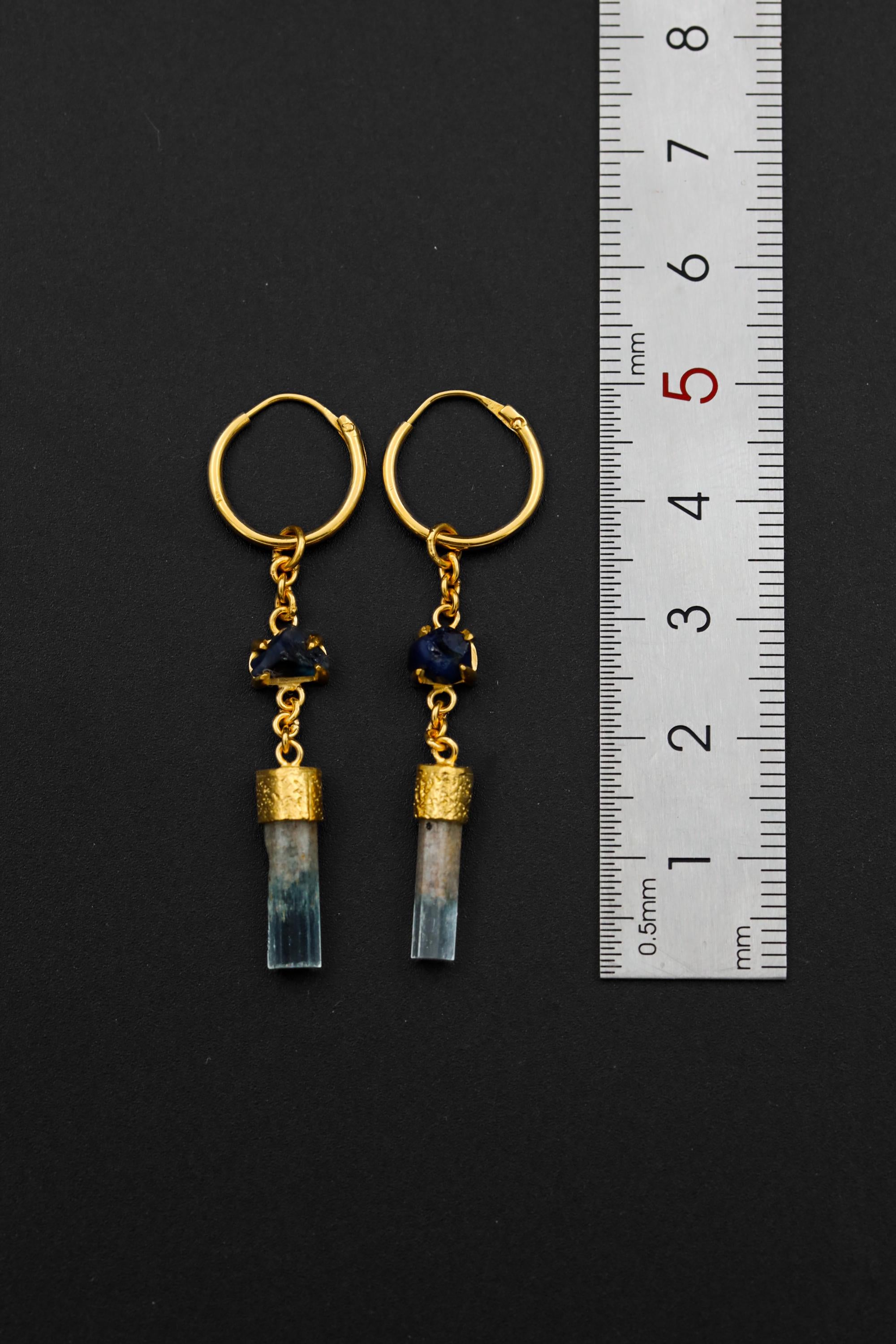 Sapphire and Aquamarine gold-plated hoop earrings shown beside a ruler for scale with petite 1 cm hoop size.