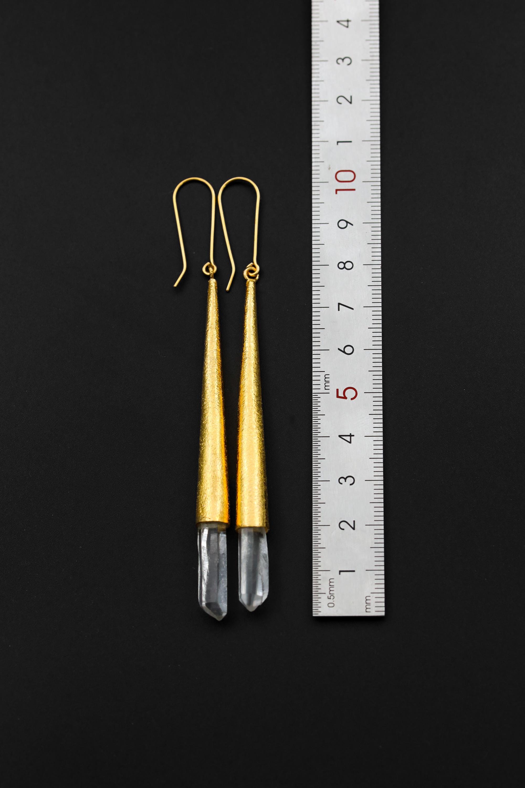 Chlorite Phantom Quartz earrings shown beside a ruler for scale, with long gold-plated sterling silver settings.