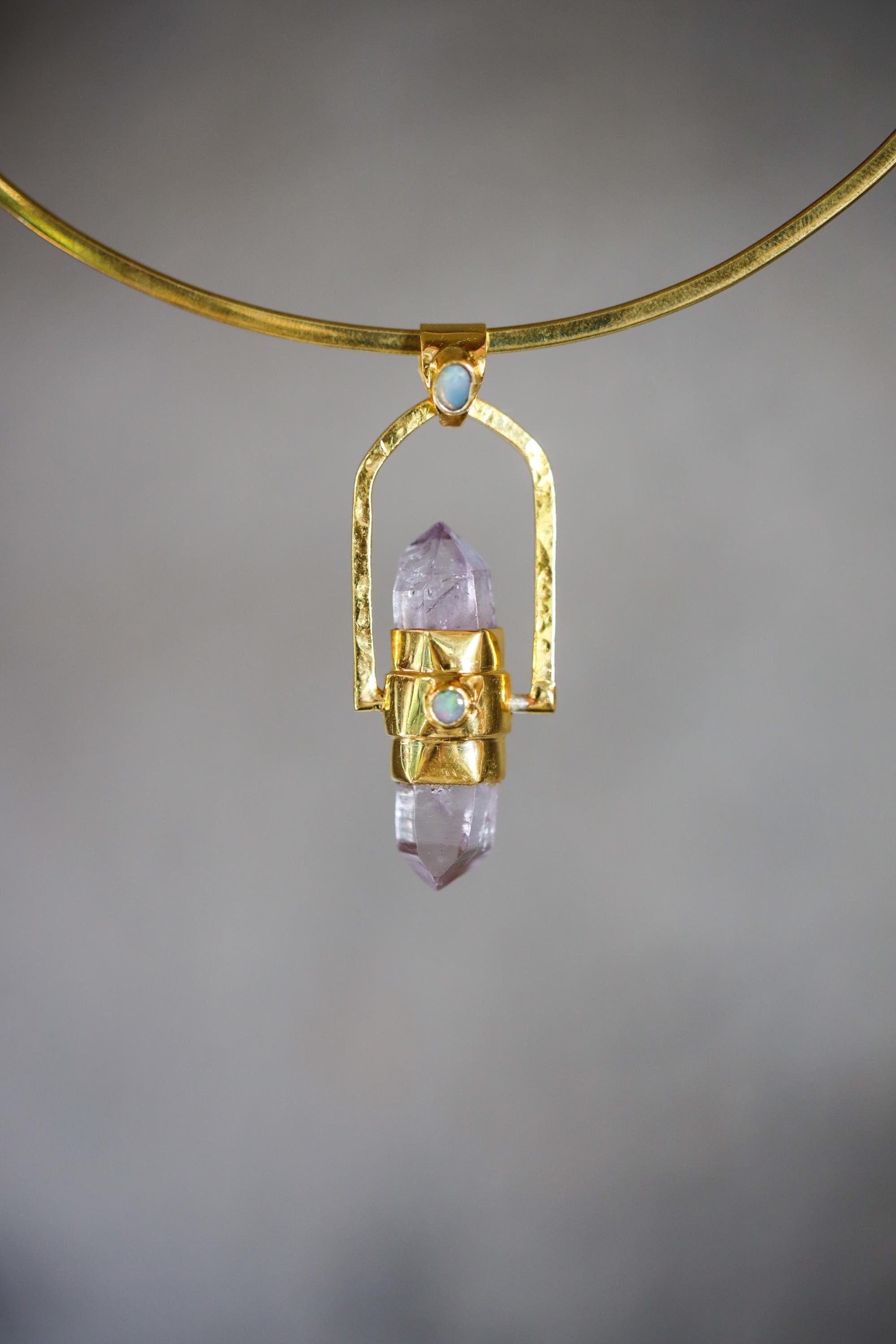 Spinning Vera Cruz Amethyst and Opal Pendant shown on soft background with high-polish sterling silver spinner setting.