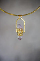 Spinning Vera Cruz Amethyst and Opal Pendant shown on soft background with high-polish sterling silver spinner setting.