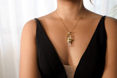 Spinning Vera Cruz Amethyst and Opal Pendant shown worn on the chest with high-polish sterling silver and gold-toned cord.