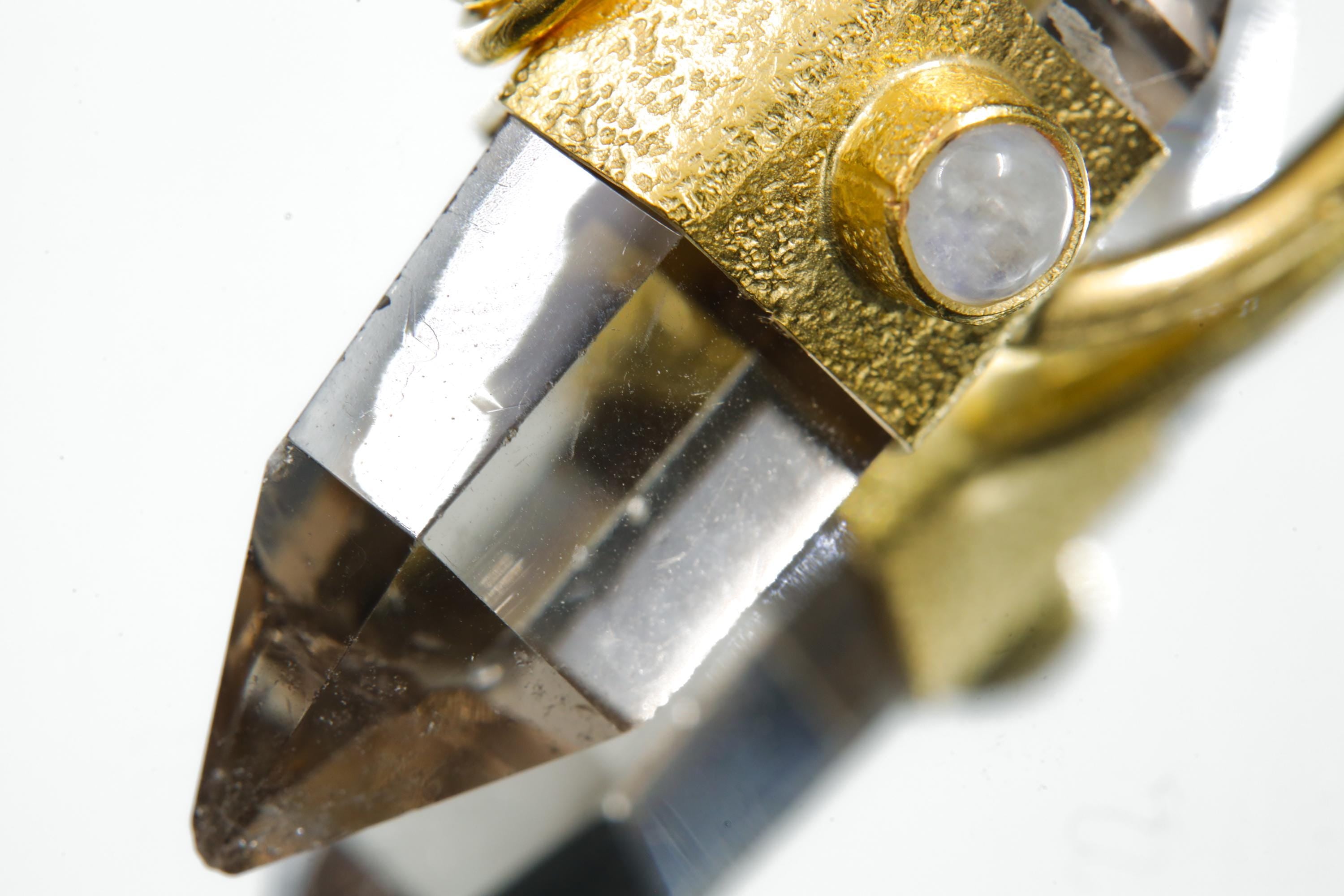 Detail view of cut Double Terminated Citrine Generator Quartz in a gold-plated halo pendant with Moonstone accent.