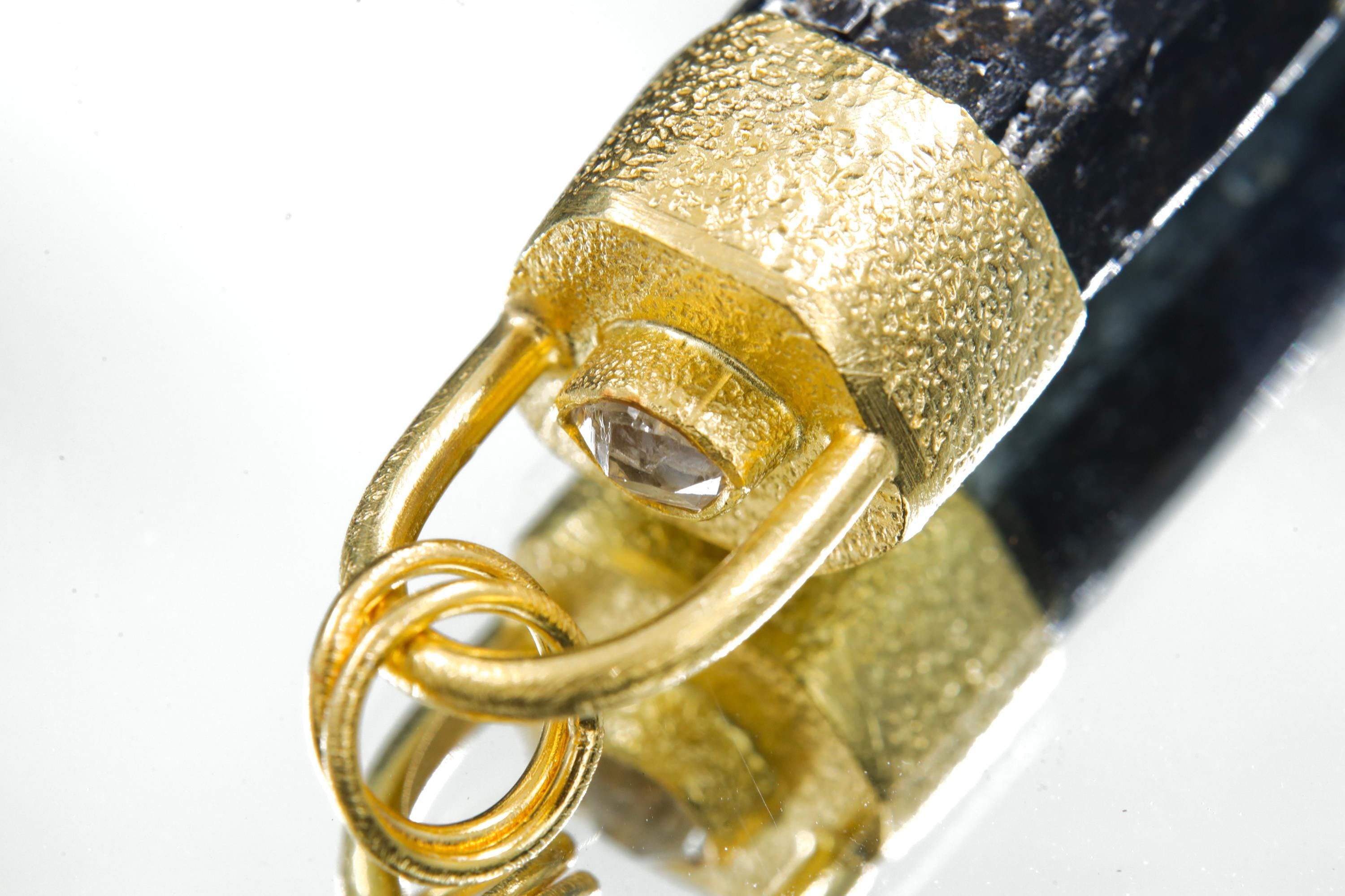 Detail view of Diamond accent and gold-plated bail on a Himalayan Dravite Tourmaline pendant.