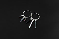 Celestial Gatherer crystal stack hoop earrings shown on dark background with sterling silver hoops and mixed gemstone dangles.