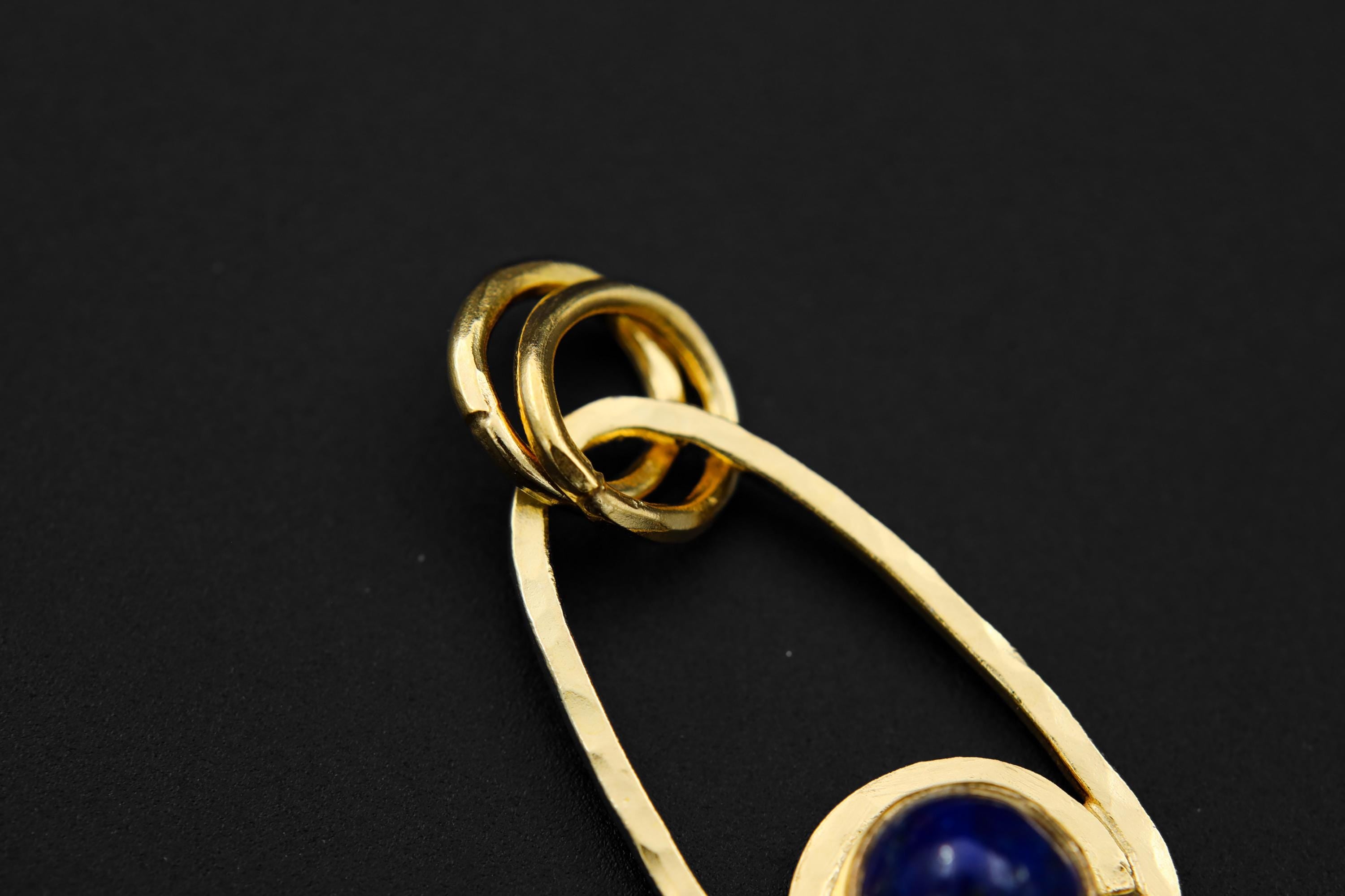 Detail view of Lapis Lazuli cosmic pendant with 18k gold-plated sterling silver, oval bails, and textured handmade rays.