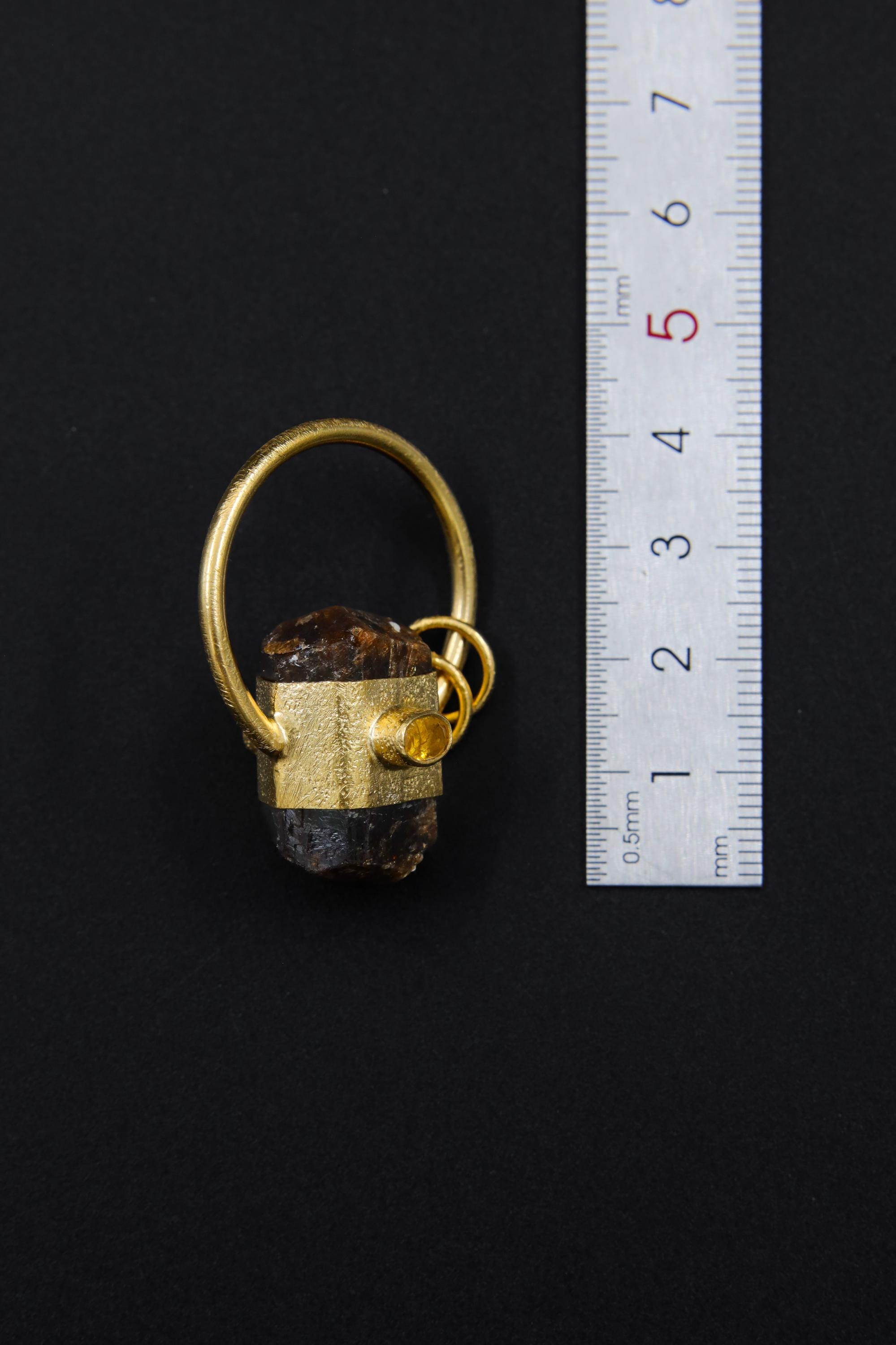 Dravite Tourmaline Ethiopian Opal halo pendant shown beside a ruler for scale, measuring approximately 3.5 to 4 cm total length including bail.