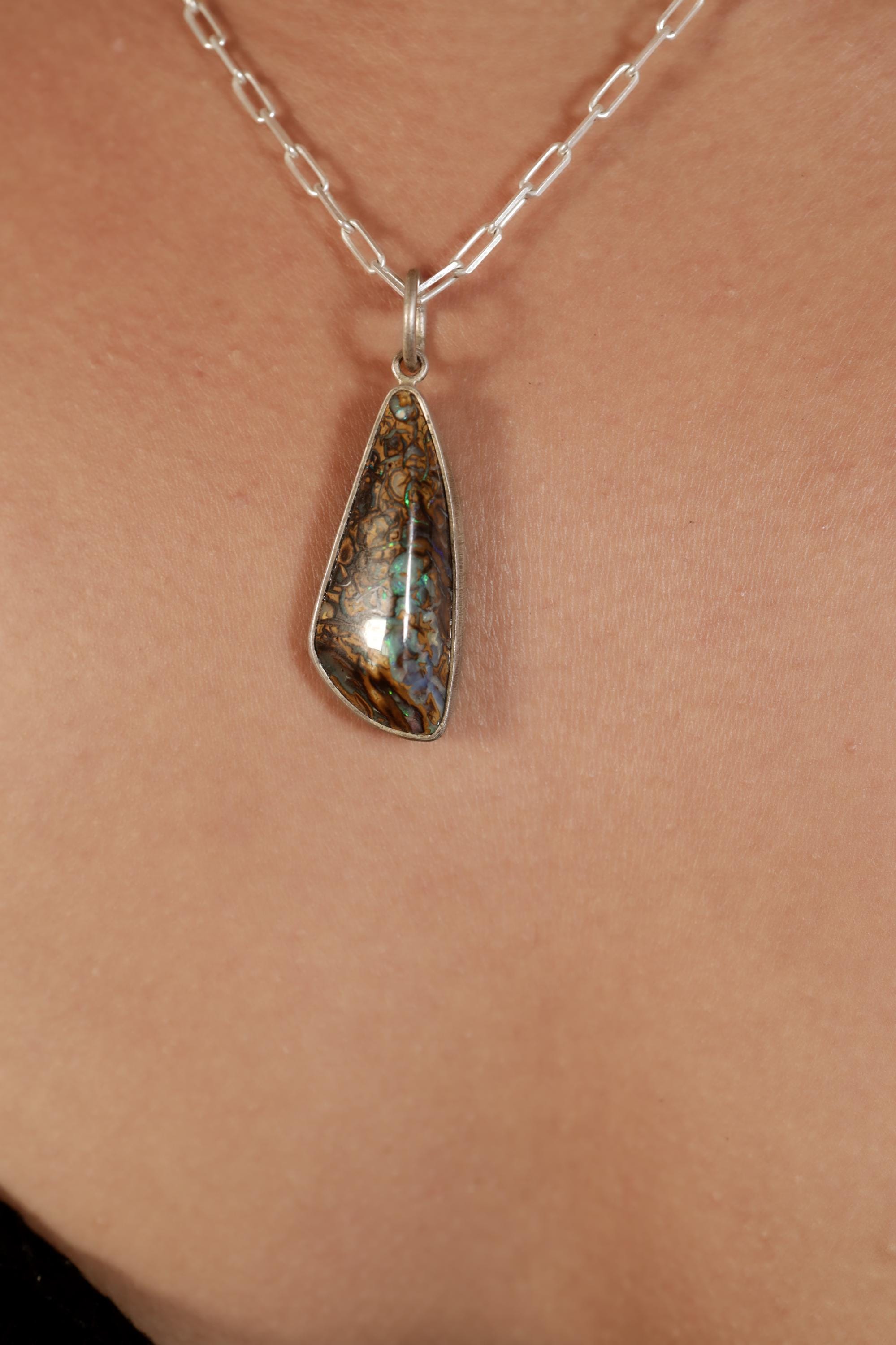 Close-up of Winton Boulder Opal showing blue, green, gold, and orange colour play within natural matrix webbing.