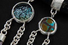 Close-up of antique Turquoise cabochons and Vera Cruz Amethyst points in a sterling silver dreamcatcher pendant.