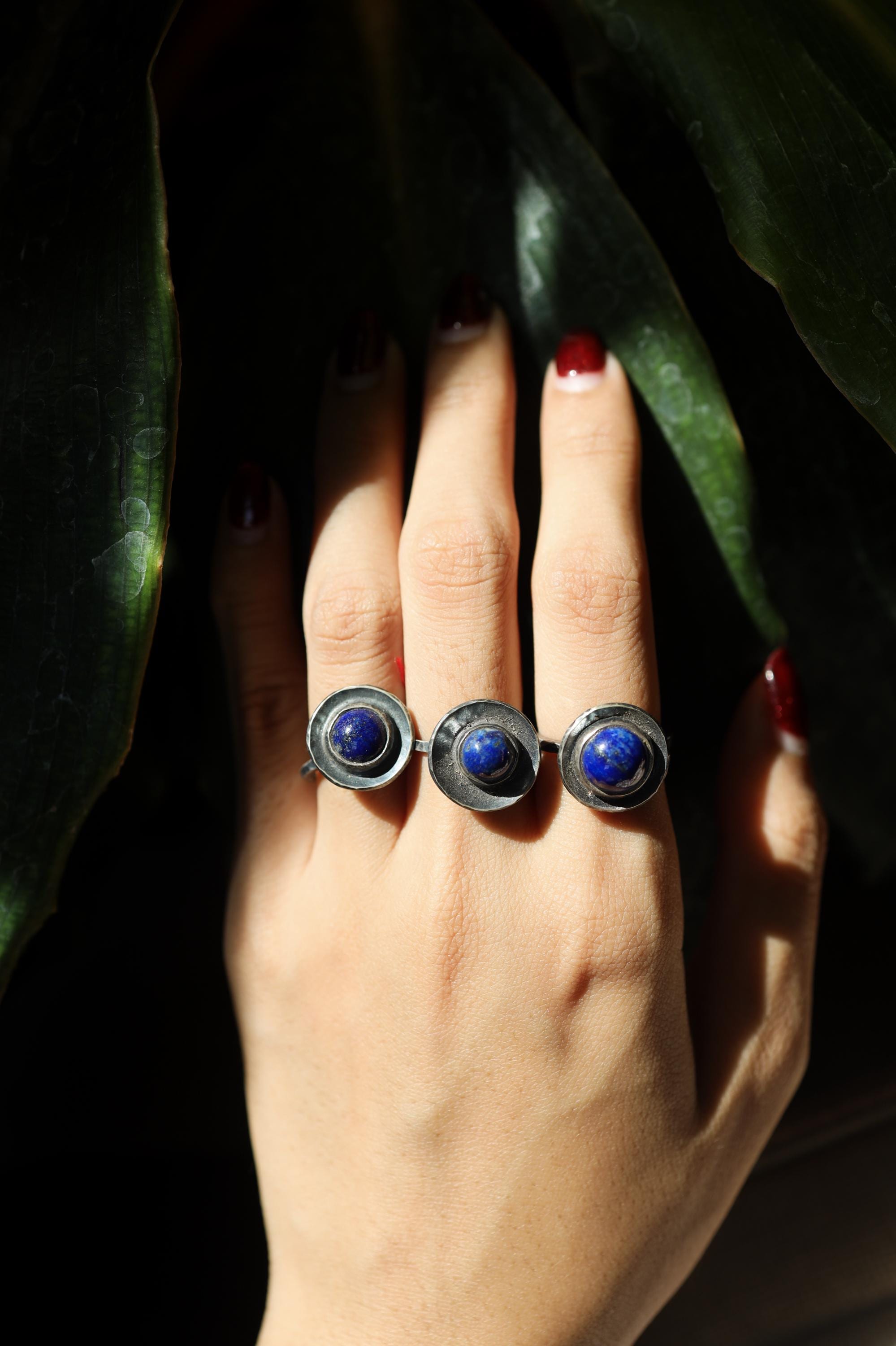 Rustic 925 sterling silver Lapis Lazuli dome ring shown worn on the hand, with deep blue round gemstone.