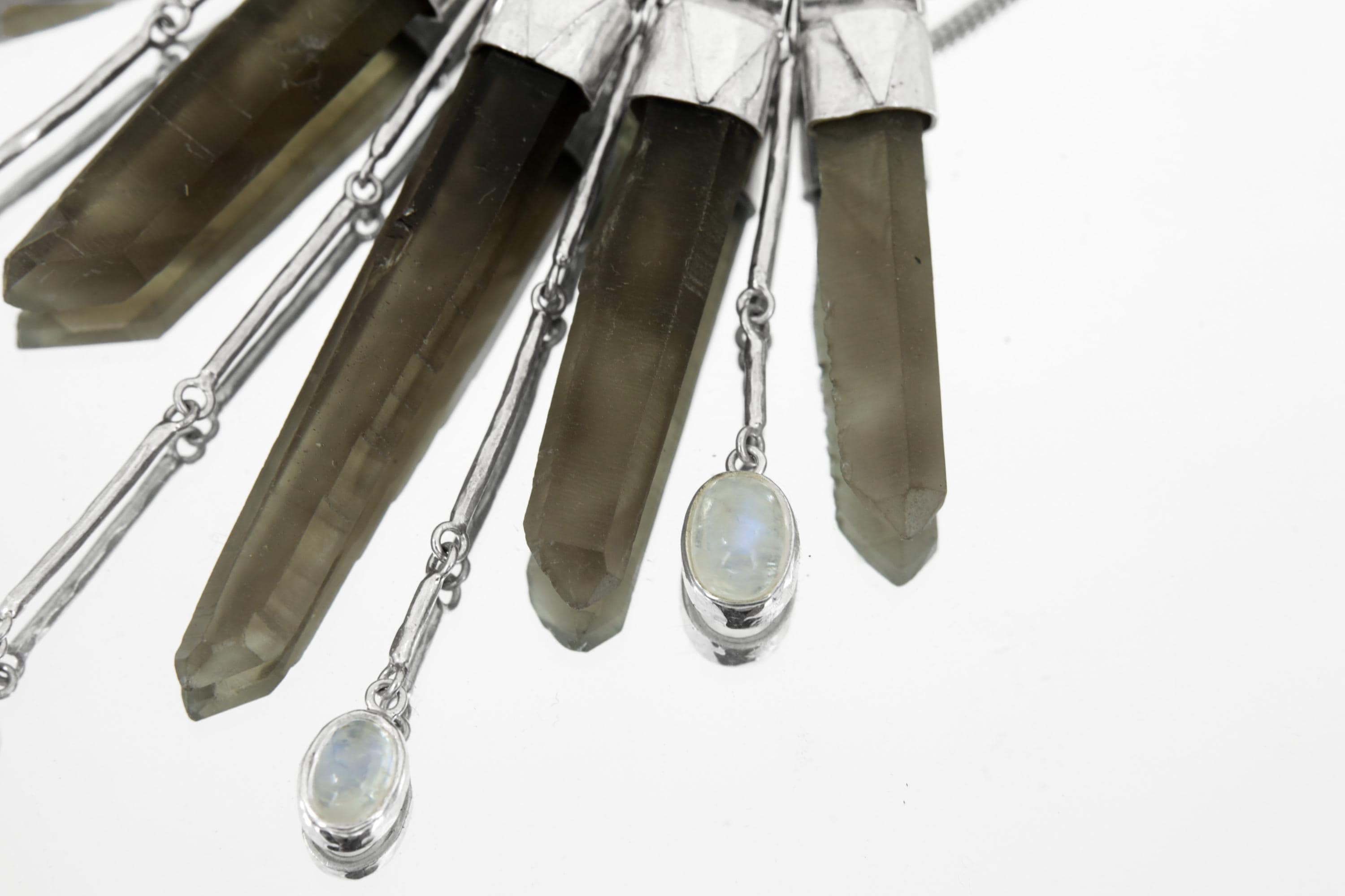 Close-up of Blue Moonstone above five Australian Smoky Citrine Phantom Quartz crystals in a sterling silver necklace.