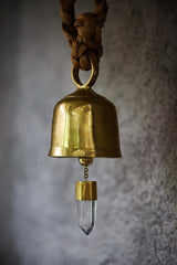 Large Clear Quartz Gold Plated Prayer Bell shown close-up with warm golden shine and suspended crystal point.