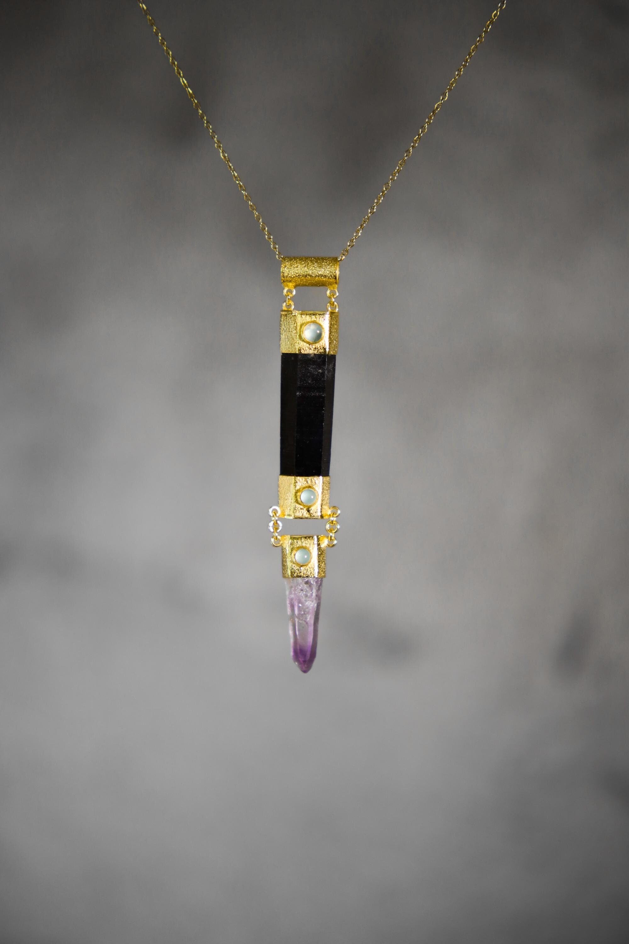 Long Black Tourmaline Aquamarine Amethyst pendant shown on a model, with 18k gold-plated sterling silver setting.