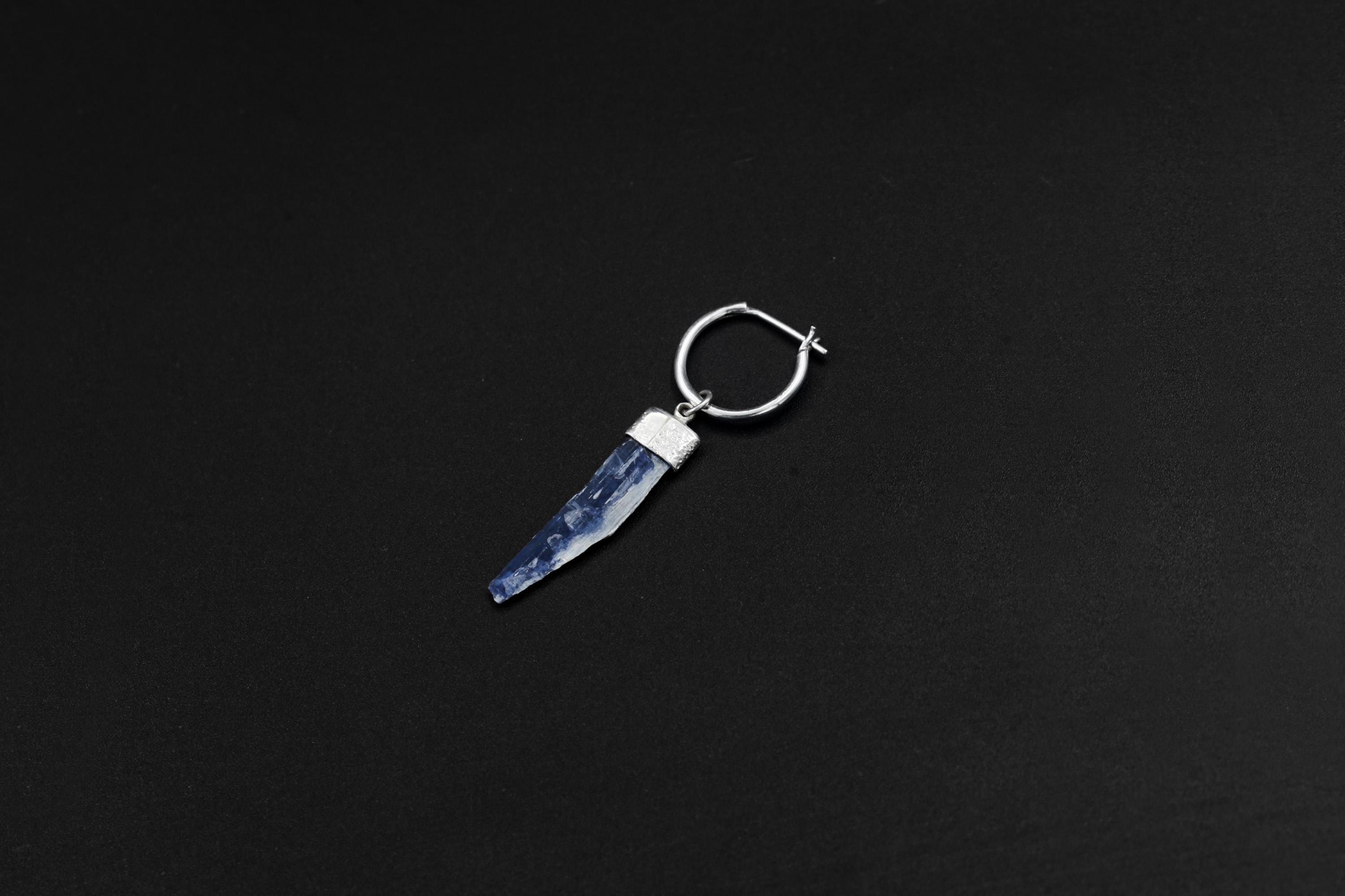 Natural Blue Kyanite single dangle earring shown on a dark background with polished sterling silver hoop fitting.