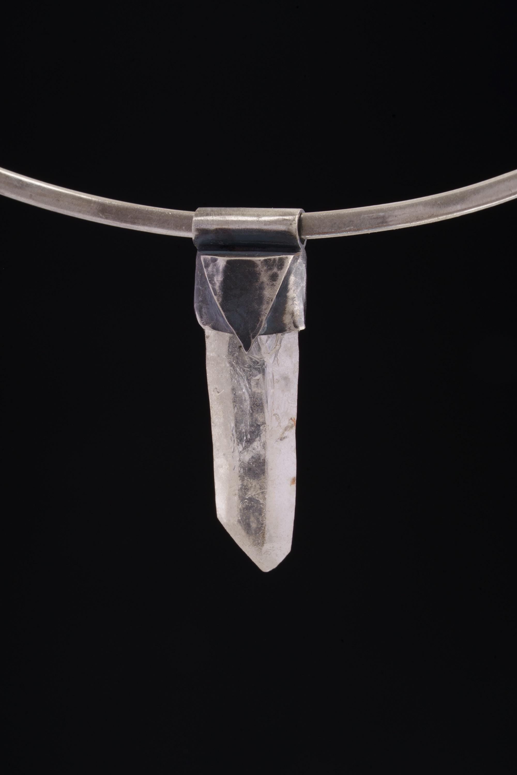 Water Clear Nepalese Inclusion Quartz Pendant shown on black background with oxidized silver cap and raw clear Quartz point.
