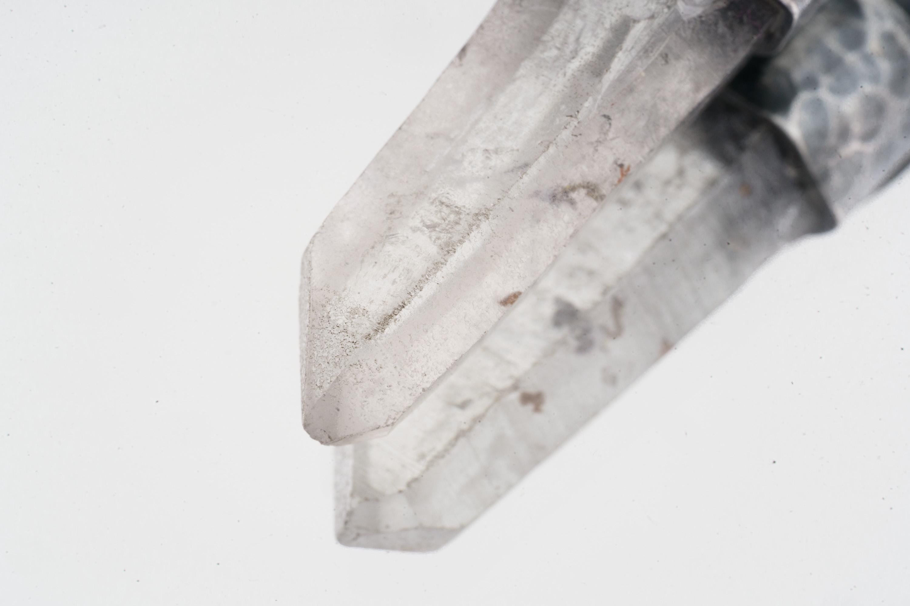 Close-up of Water Clear Nepalese Inclusion Quartz showing natural internal inclusions, bright clarity, and raw crystal texture.