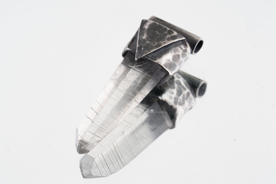 Water Clear Nepalese Inclusion Quartz Pendant shown on white background with hand-hammered geometric silver cap and clear crystal body.
