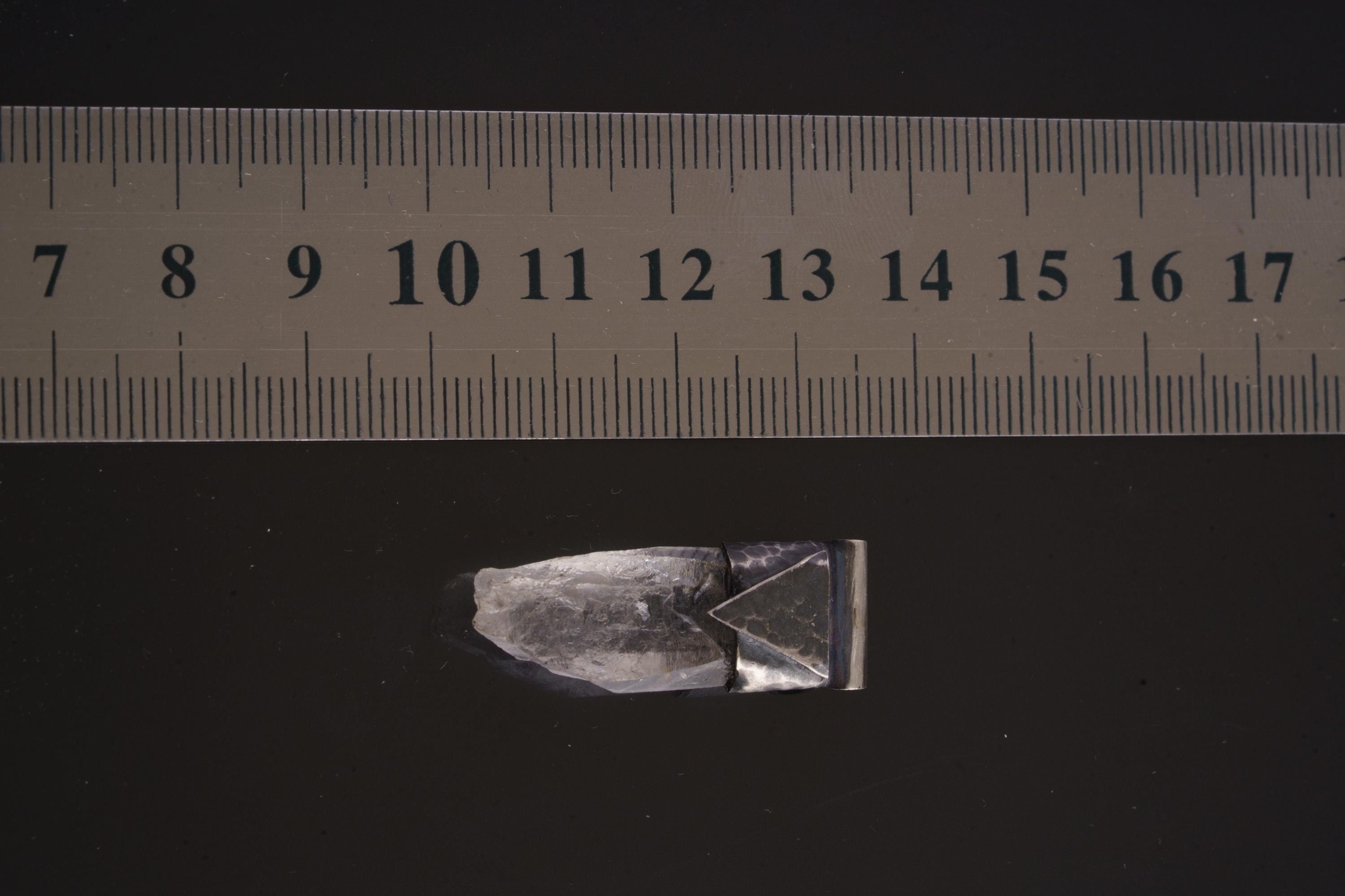Water Clear Nepalese Inclusion Quartz Pendant shown beside a ruler for scale with oxidized silver cap and clear crystal body.