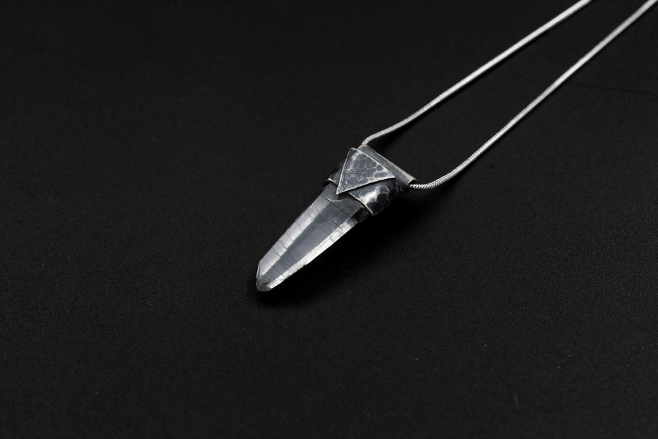 Water Clear Nepalese Inclusion Quartz Pendant shown on black background with black cotton necklace and raw clear Quartz point.