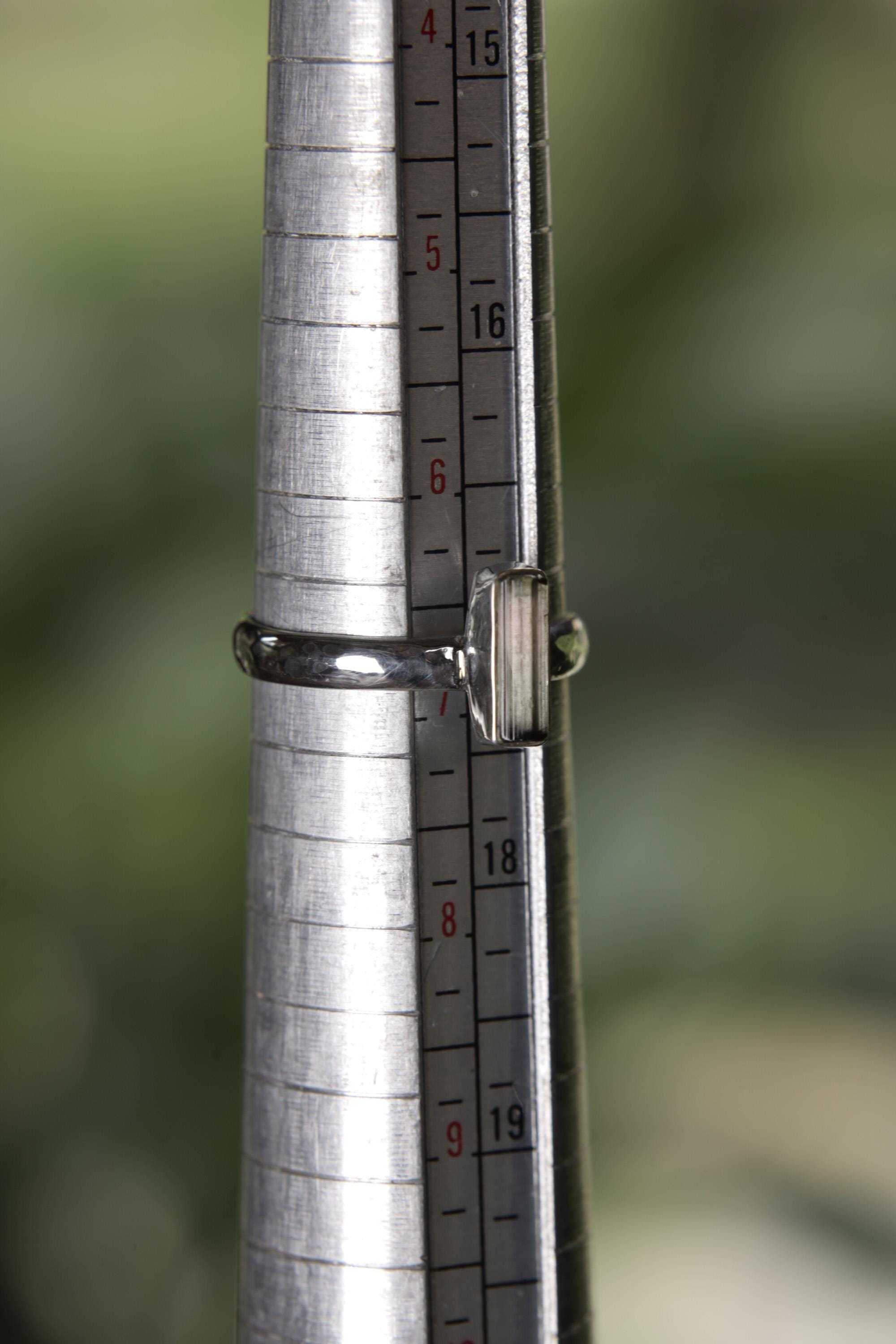 Watermelon Tourmaline sterling silver ring shown on a ring mandrel at approximately US size 7 for sizing reference.