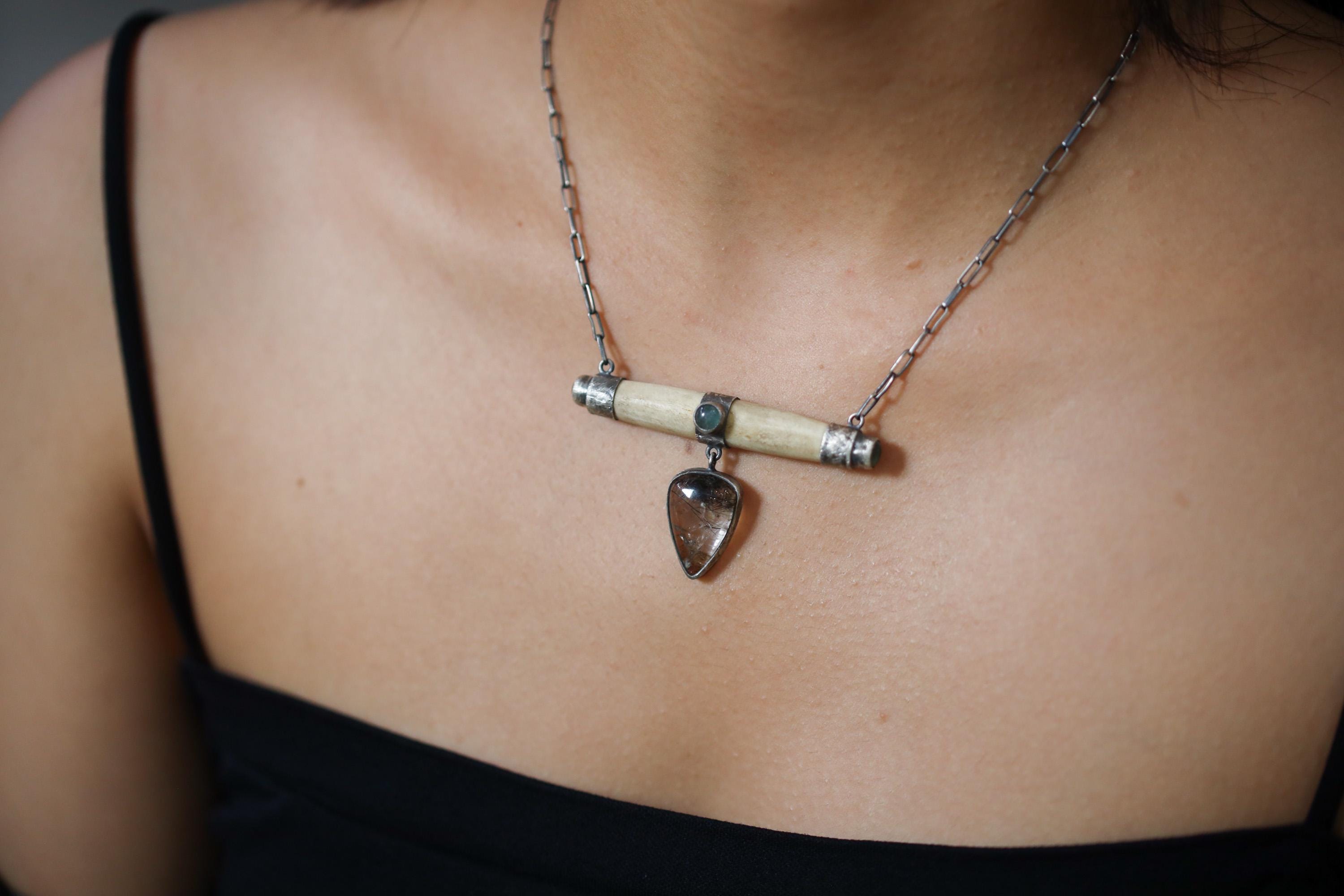 Aquamarine Bone Black Rutile Quartz necklace shown worn close to the collarbone on a 14 to 16 inch sterling silver box chain.