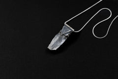 Water Clear Nepalese Inclusion Quartz Pendant shown on black background with oxidized sterling silver cap and black cotton necklace.