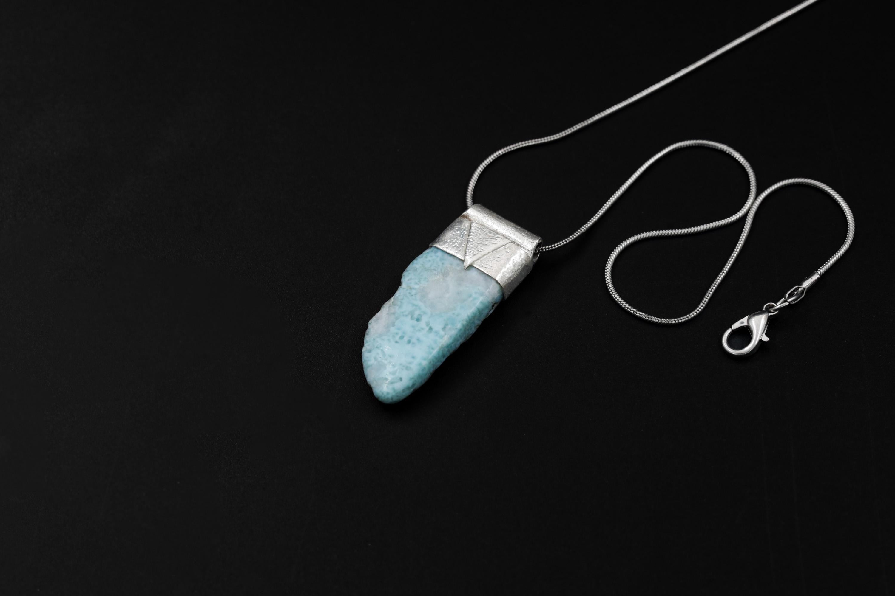 Freeform Larimar Stack Pendant shown on black background with adjustable black cotton necklace and organic silver cap.