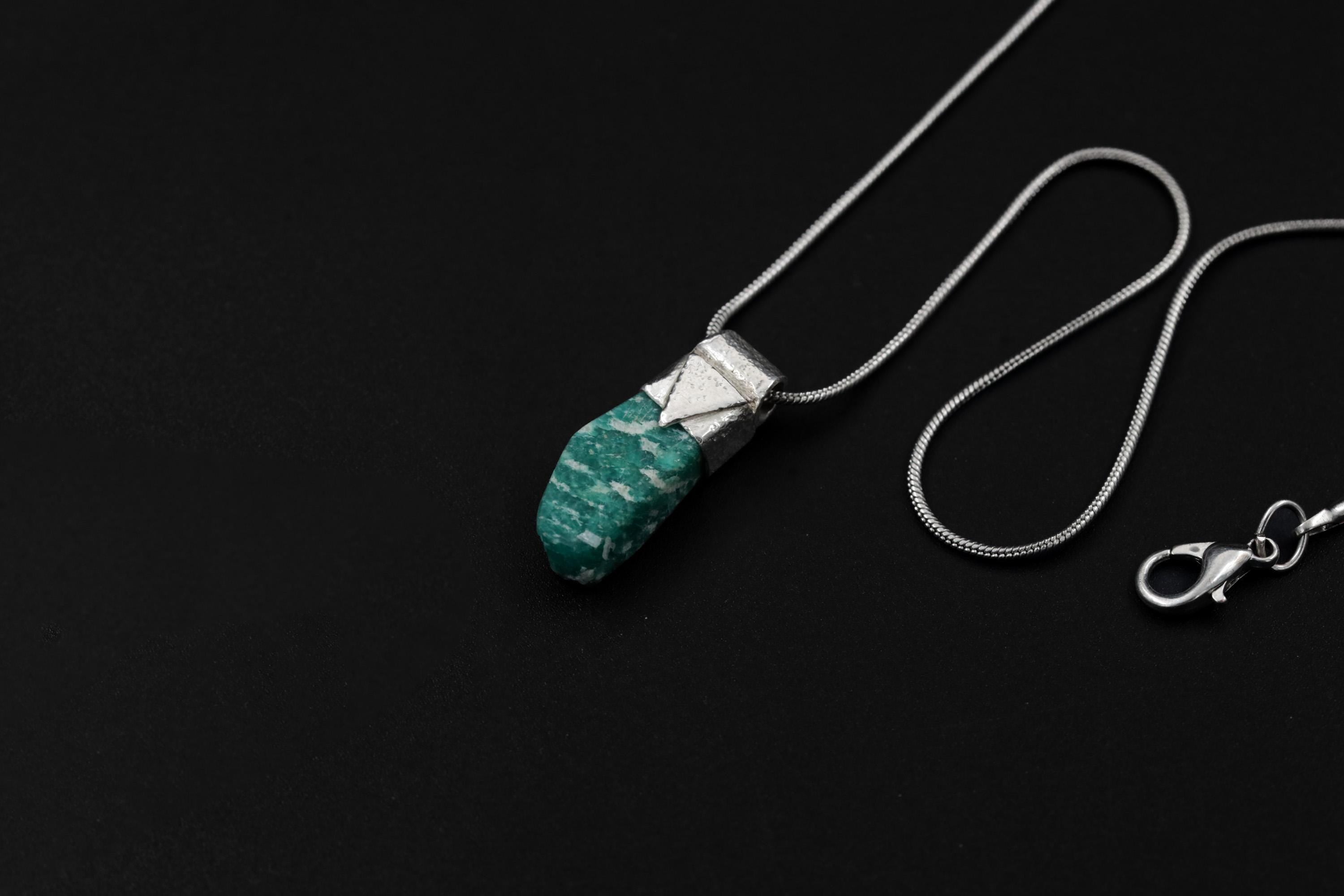 Rough Cut Amazonite Stack Pendant shown on black background with adjustable black cotton necklace and textured silver cap.