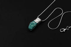 Rough Cut Amazonite Stack Pendant shown on black background with adjustable black cotton necklace and textured silver cap.