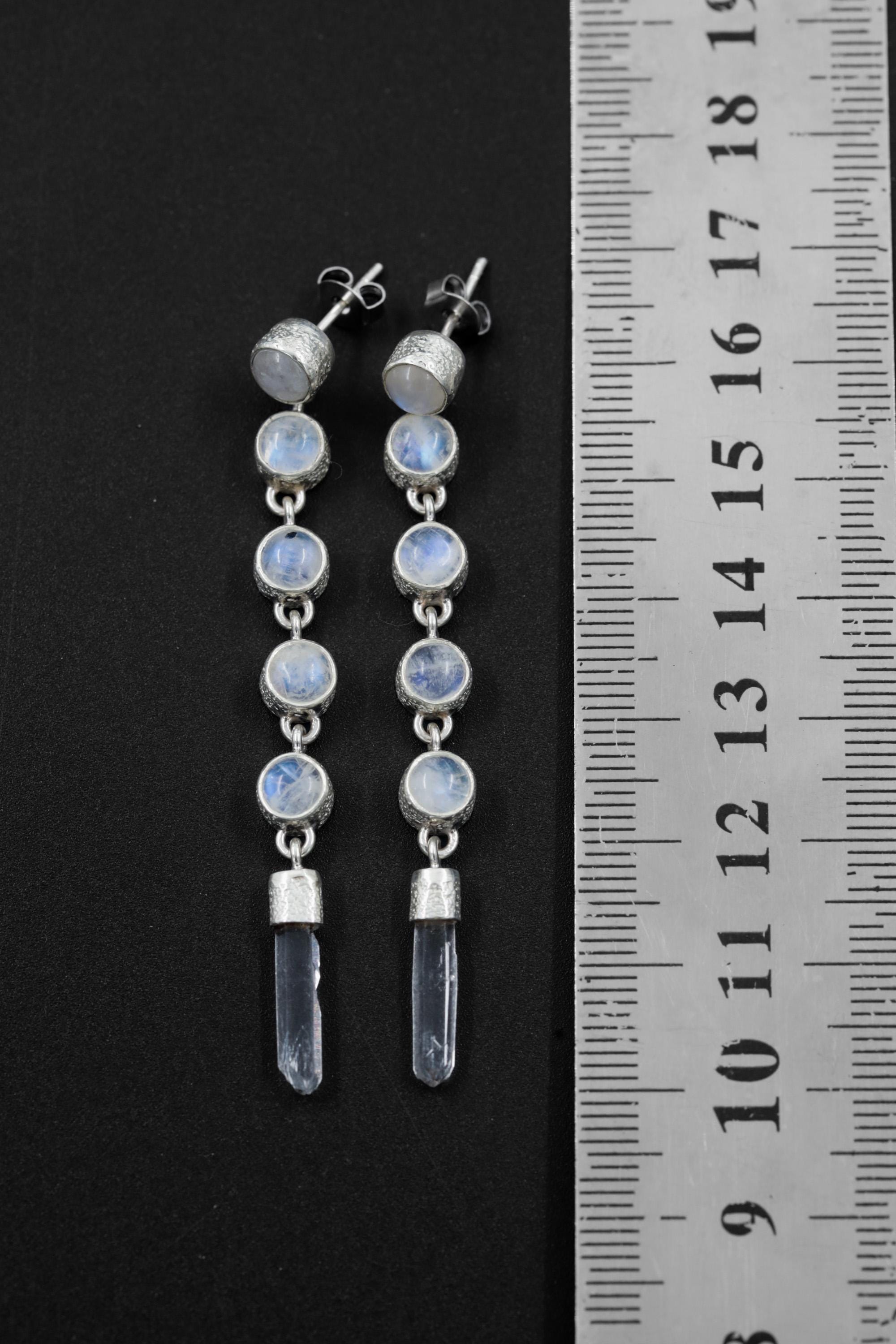 Blue Moonstone and Clear Quartz sterling silver drop earrings shown beside a ruler for length reference.