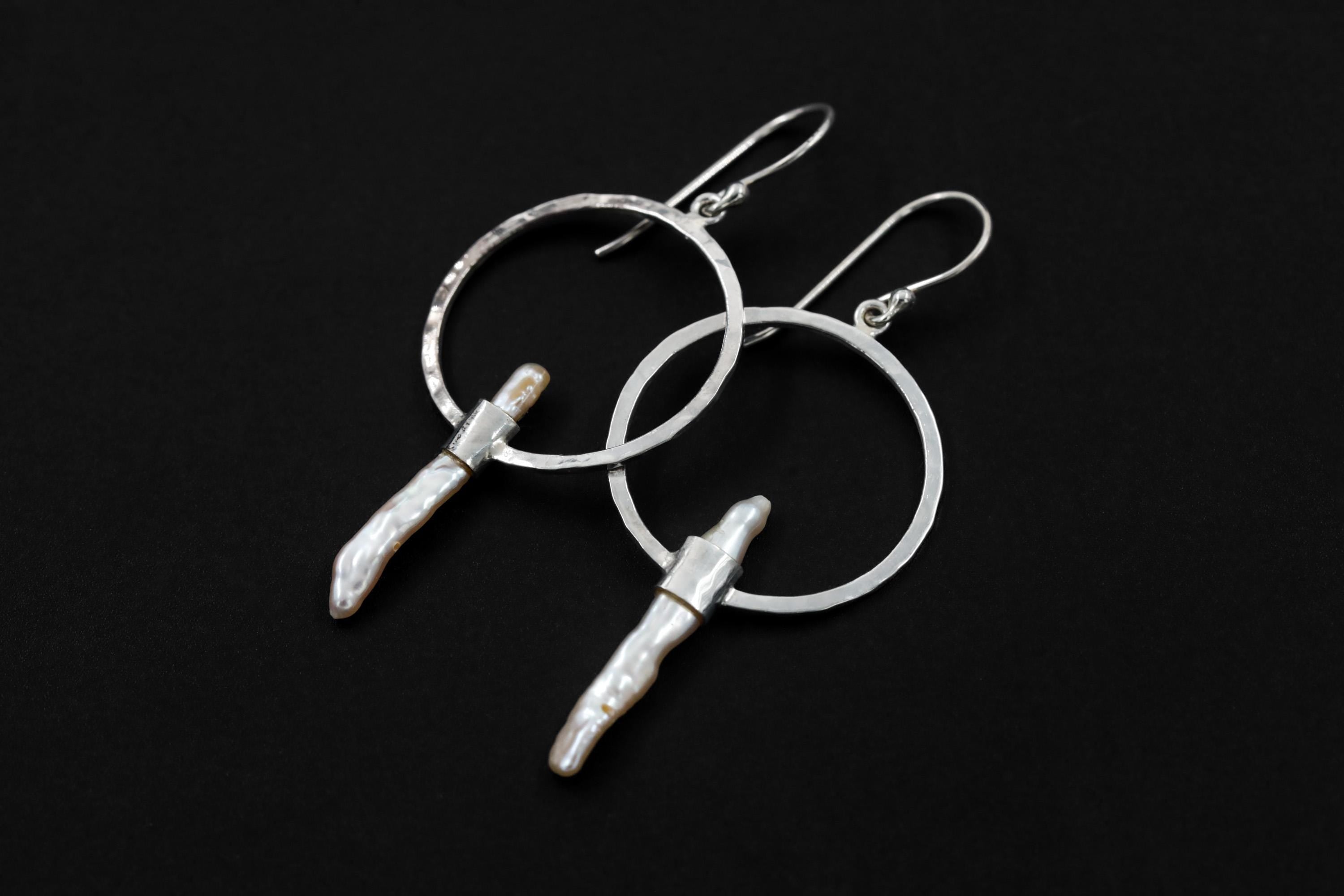 Baroque Pearl earrings shown on a dark background with hammered sterling silver hoops and organic Pearl drops.