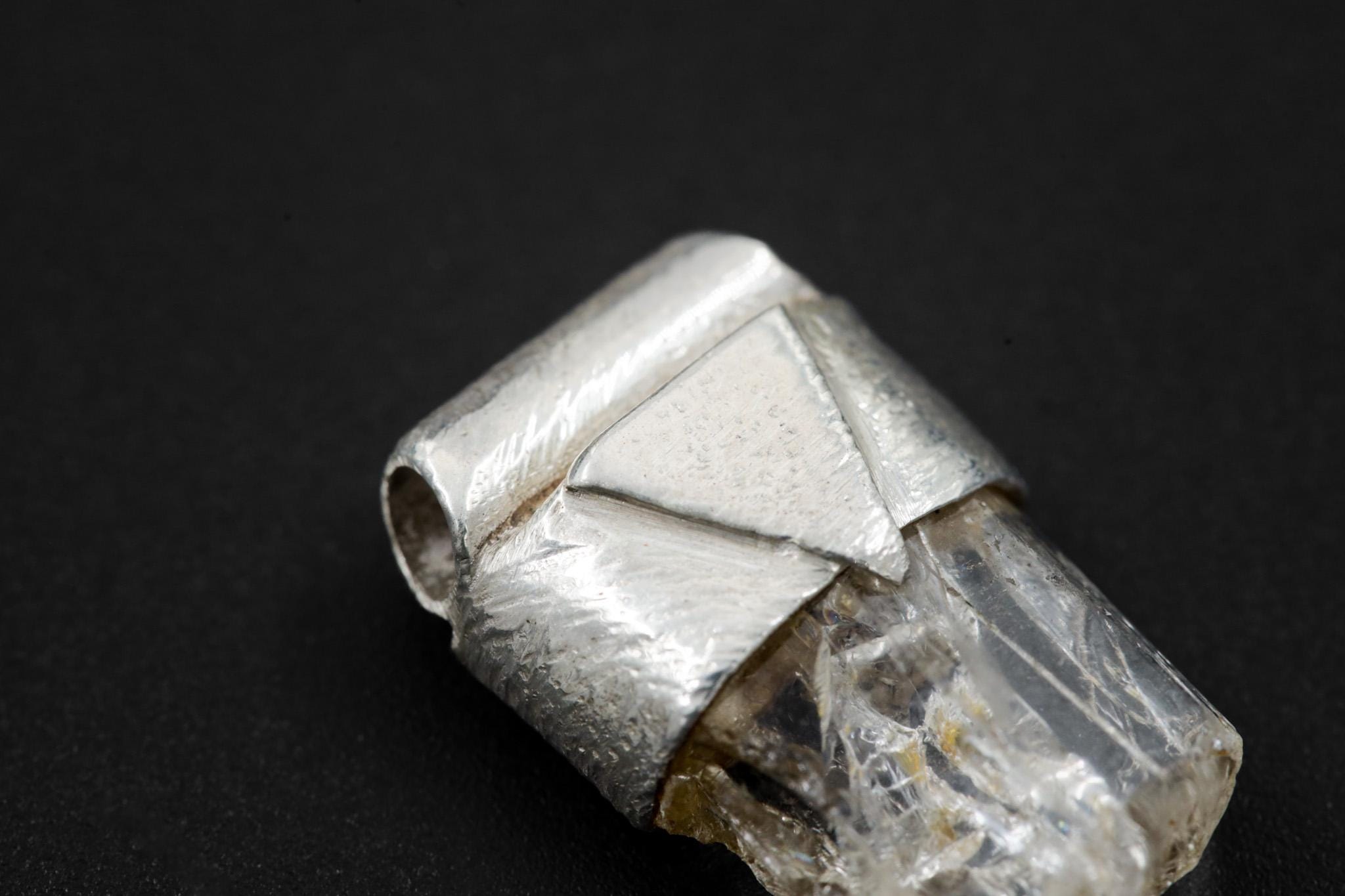 Close-up of Clear Rainbow Inclusion Spodumene showing internal rainbow flashes, raw crystal texture, and sterling silver cap.