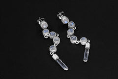 Blue Moonstone and Clear Quartz sterling silver cascade earrings shown on dark background with long crystal drops.