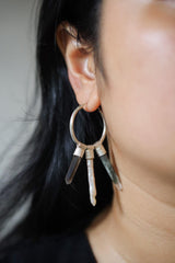 Crystal stack hoop earring worn on a model, showing large sterling silver hoop and layered gemstone movement.