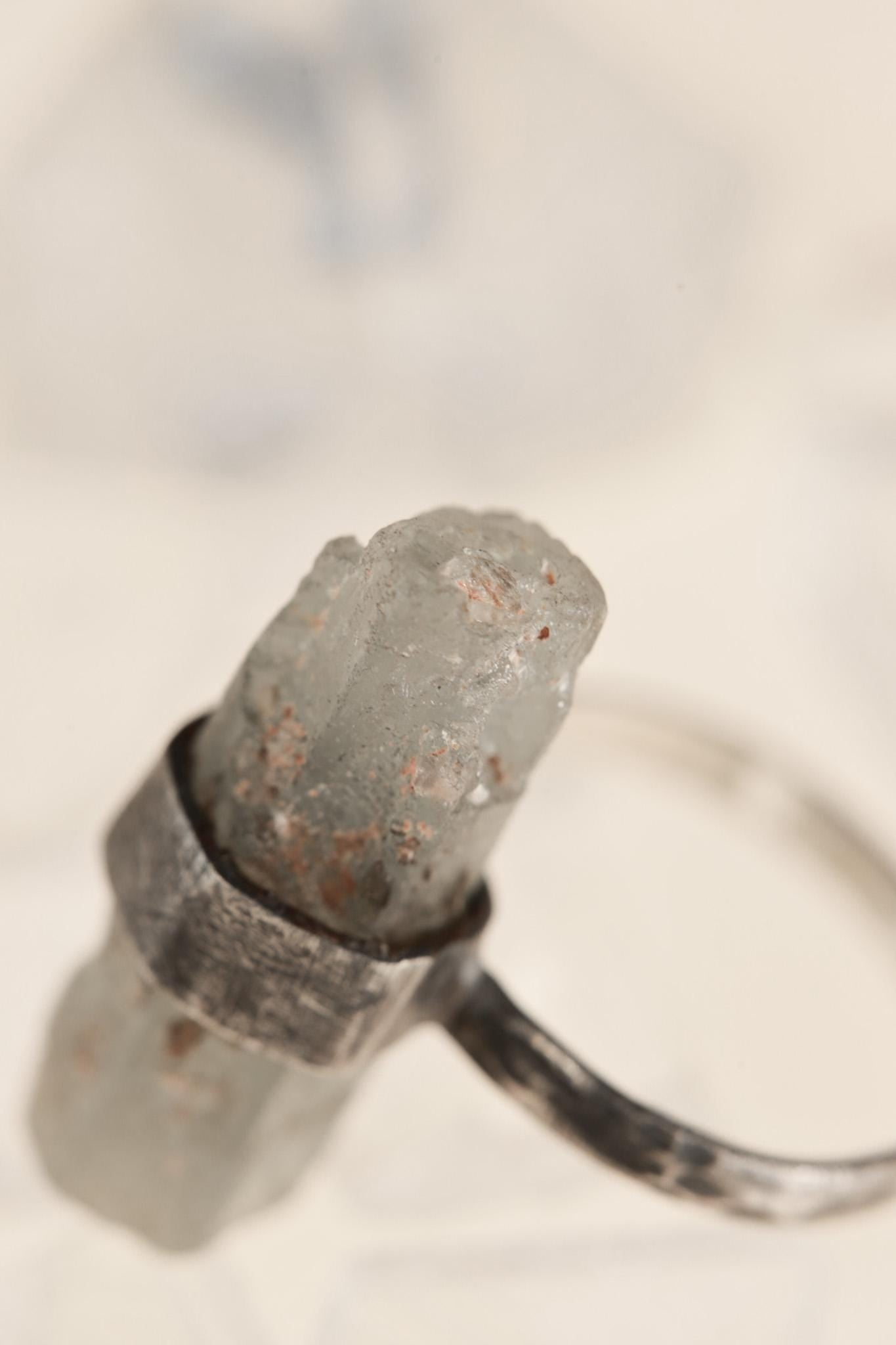 Close-up of Torrington Aquamarine ring showing raw crystal texture and wide brushed silver wrap.