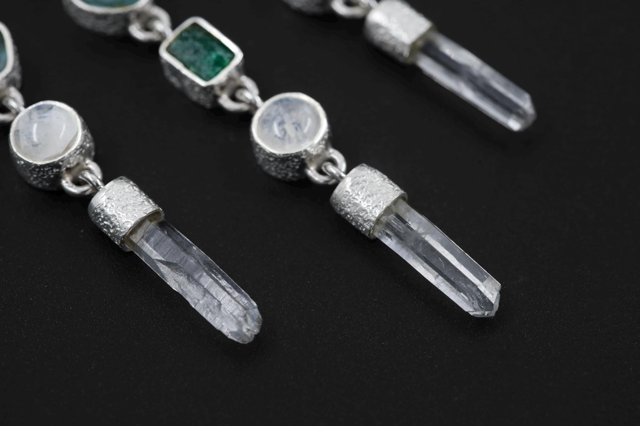 Three Clear Quartz and gemstone dangles hanging below a Pink Kunzite bar in a sterling silver Aurora Alignment necklace.