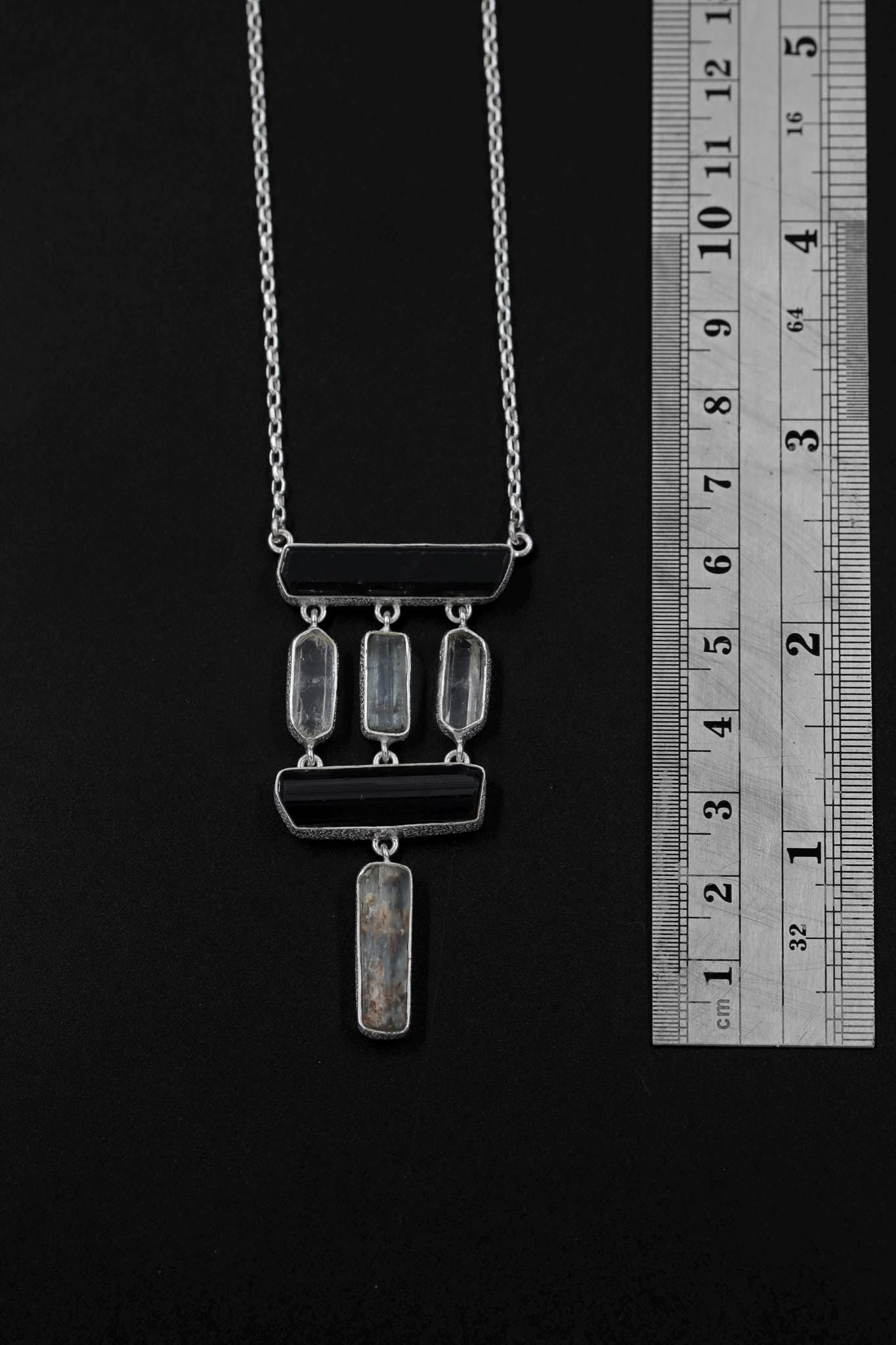 Black Tourmaline Quartz Aquamarine pendant shown beside a ruler for scale, with high-shine silver and geometric stone layout.
