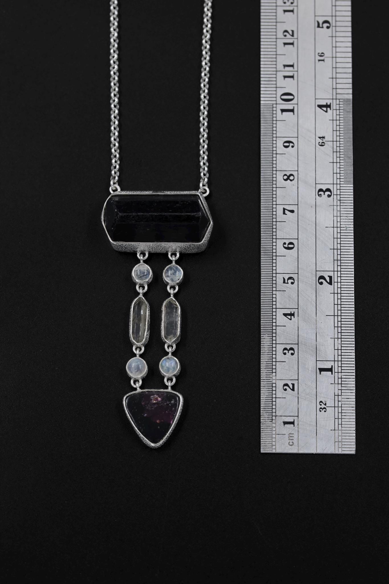 Celestial Pathways Talisman shown beside a ruler for scale, with vertical crystal arrangement and 16 to 18 inch rolo chain.