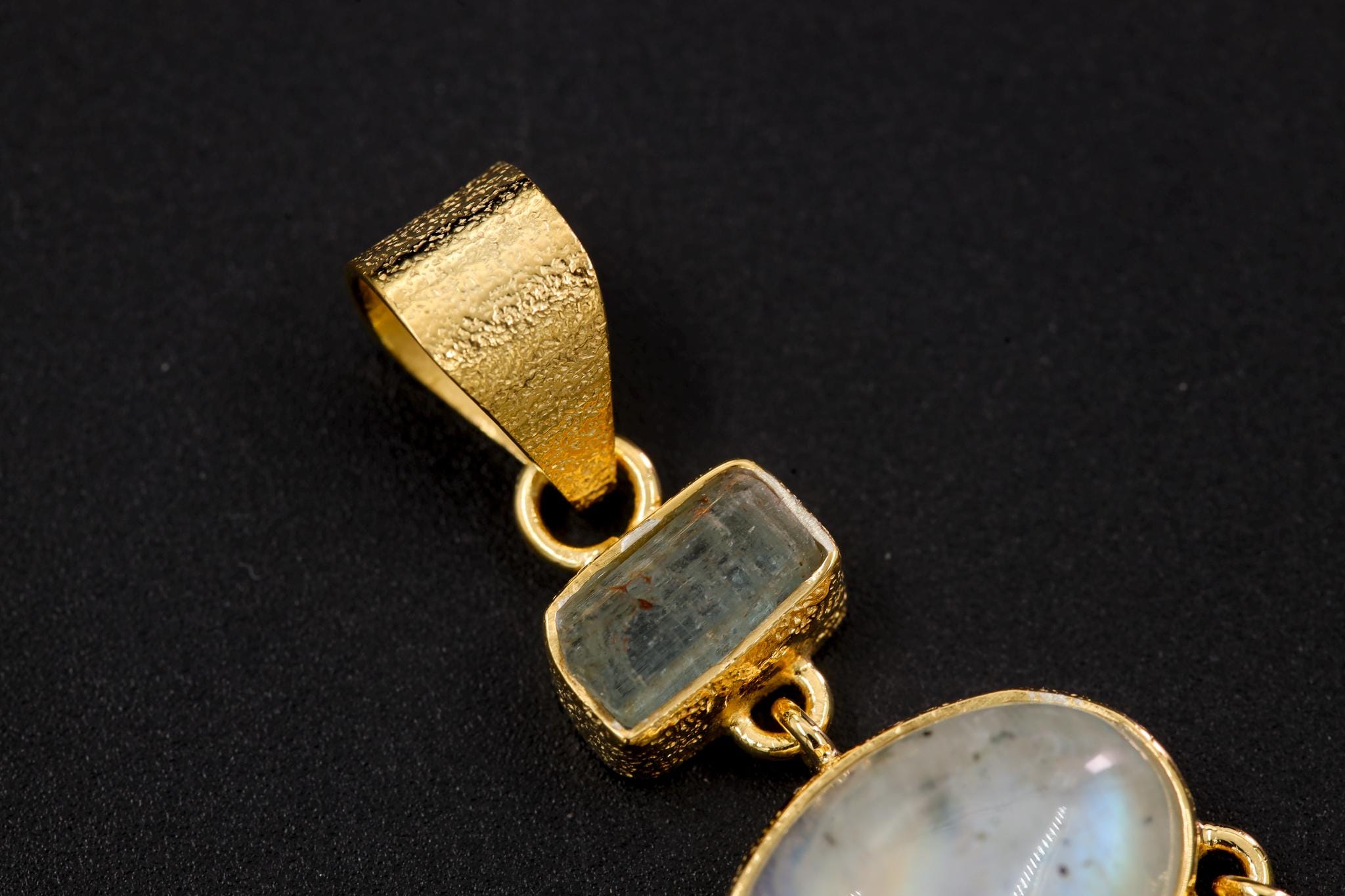 Close-up of gold-plated Aquamarine Moonstone pendant with Clear Quartz point dangles and classic 7 mm bail.
