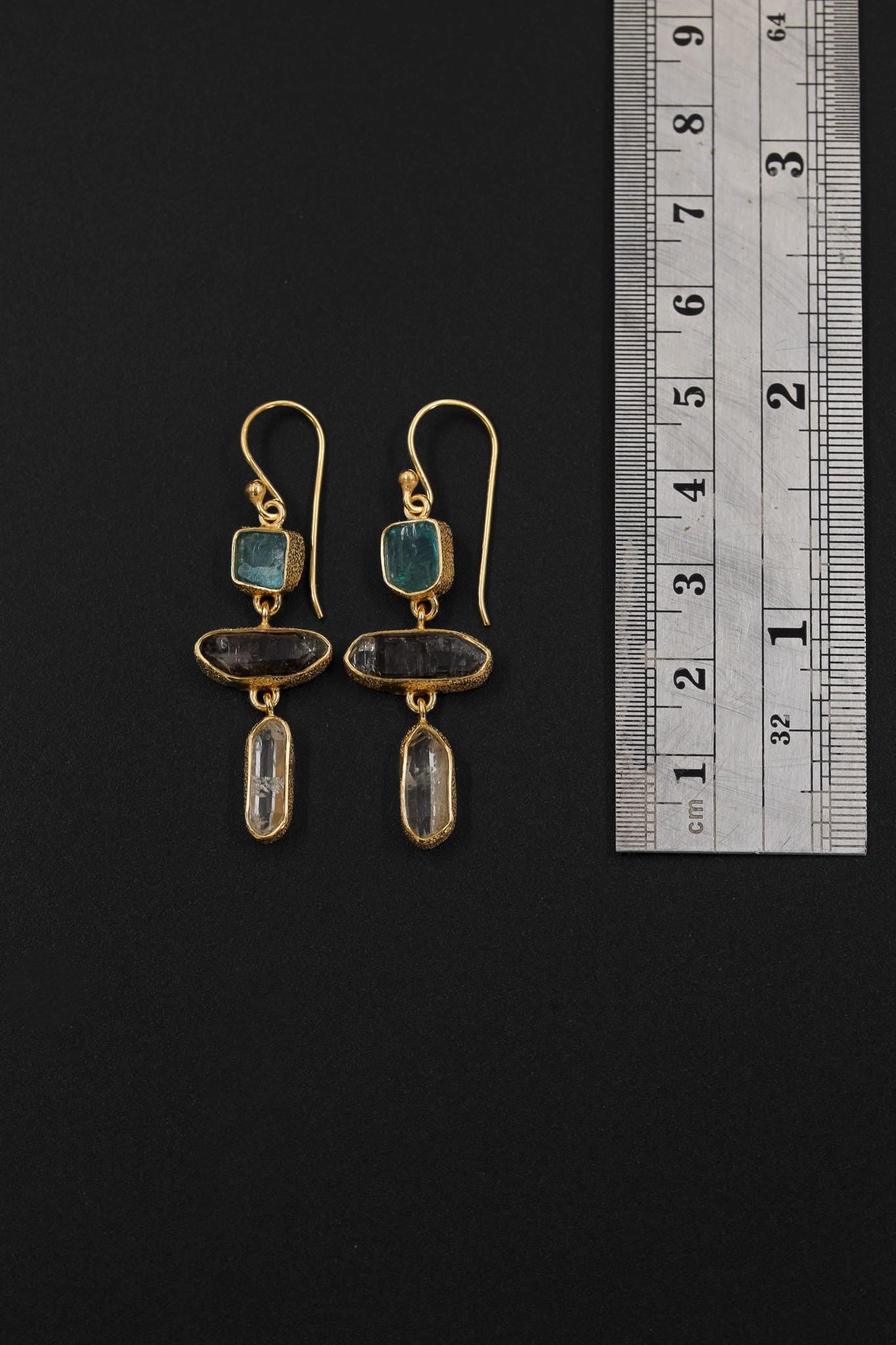 Whispers of the Wellspring earrings shown beside a ruler for scale, with 5 cm gold vermeil gemstone dangles.