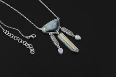 Blue Tourmaline Aquamarine Angel Aura Quartz Moonstone necklace shown on a dark background with sterling silver box chain.